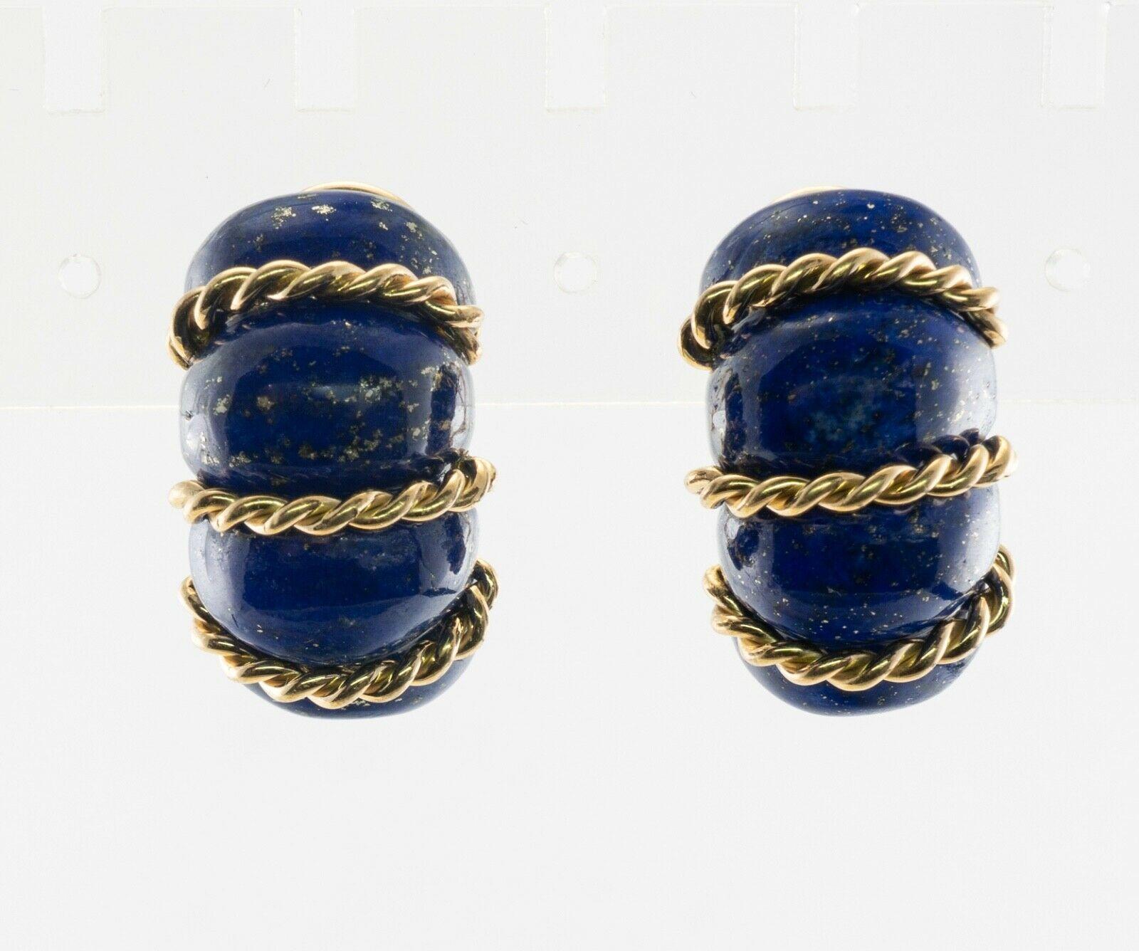 A sophisticated take on a classic hoop design, compliments of iconic American jeweler Seaman Schepps. Sensuously styled sections of lapis lazuli alternate with a twisted rope design, symbiotically creating a sculpture that resembles a shrimp. They