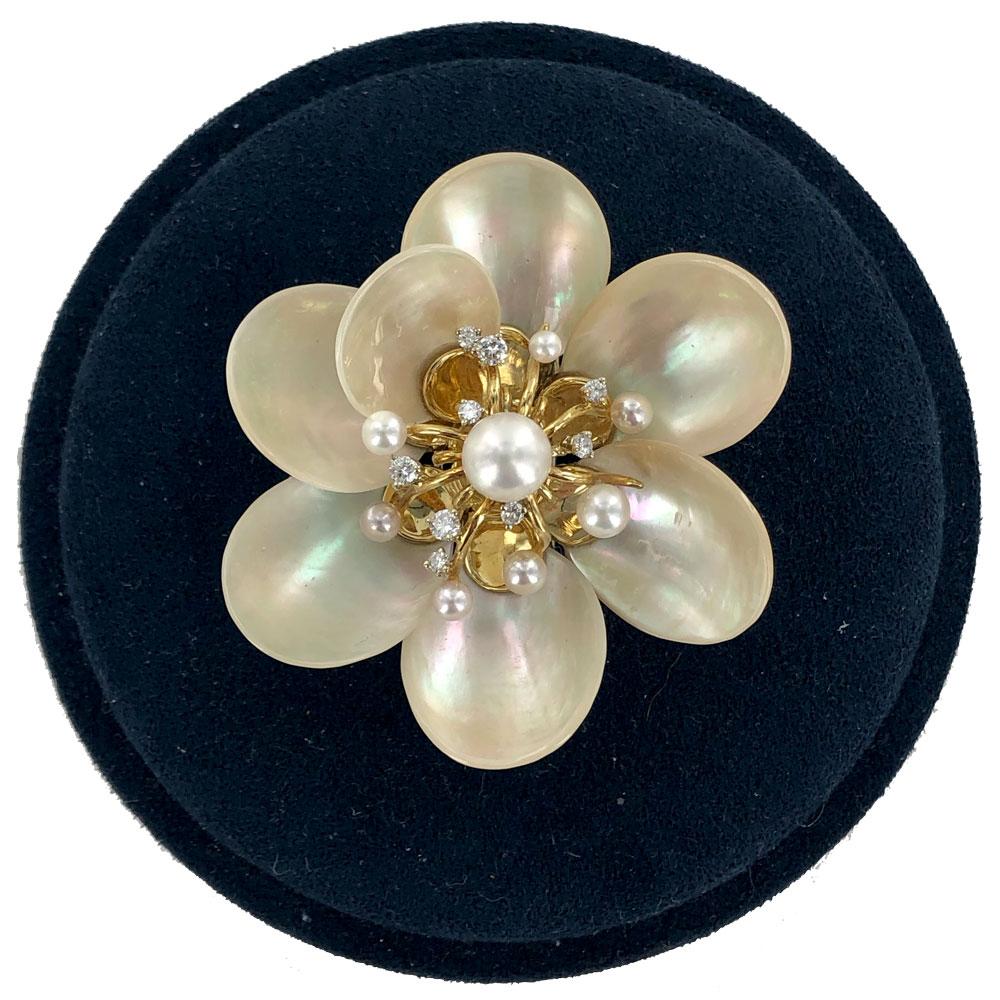 Fabulous vintage brooch handcrafted in mother of pearl, 18 karat gold, and diamonds by designer Seaman Schepps. The unique piece features 9 round brilliant cut diamonds weighing .50 carat total weight and graded F color and VS clarity. The pin