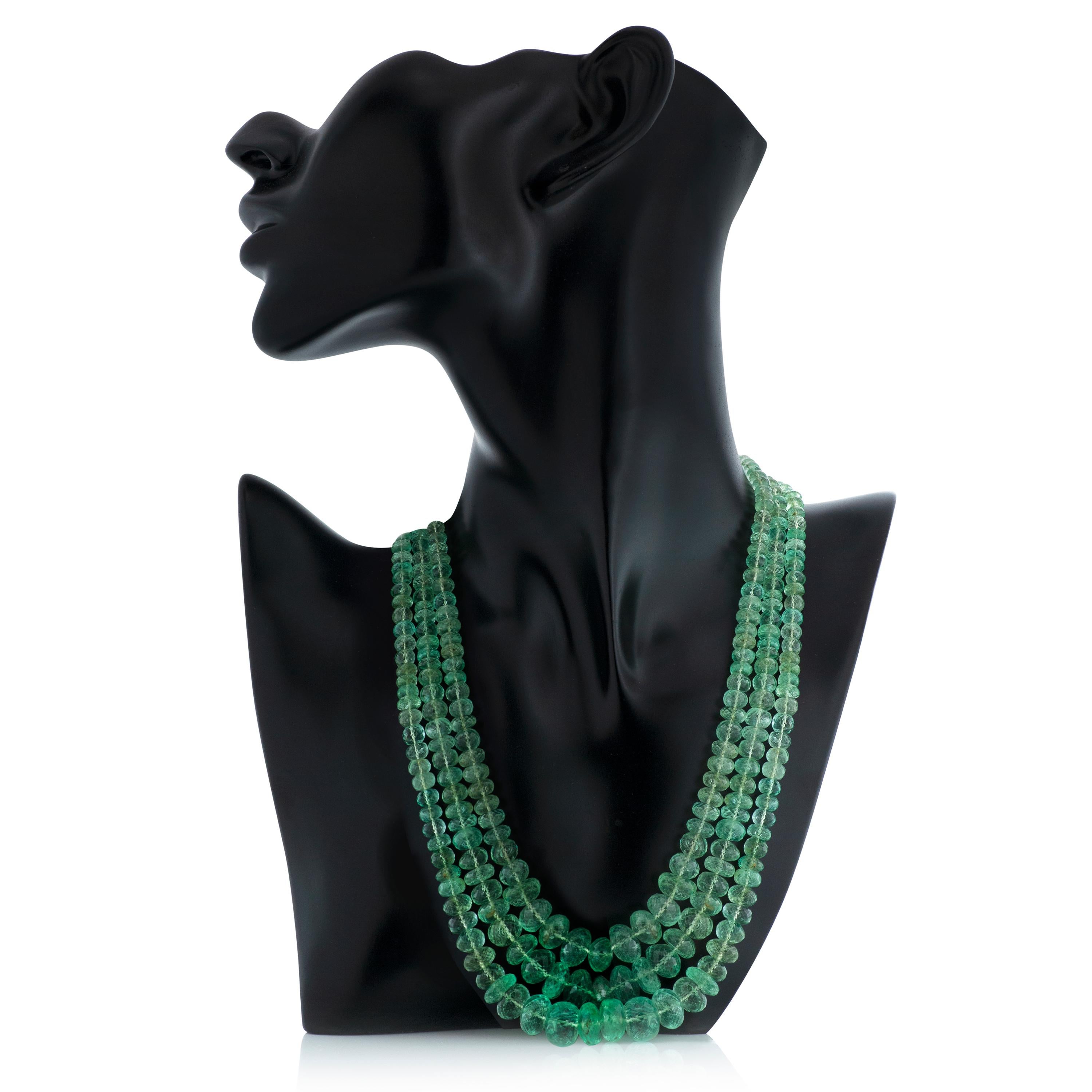 Vintage Seaman Schepps multi-strand faceted green beryl bead necklace with 18k yellow gold and diamond clasp.

This necklace features 3 strands of faceted green beryl beads graduating from approximately 5mm to 12.5mm.  The clasp contains 7 round