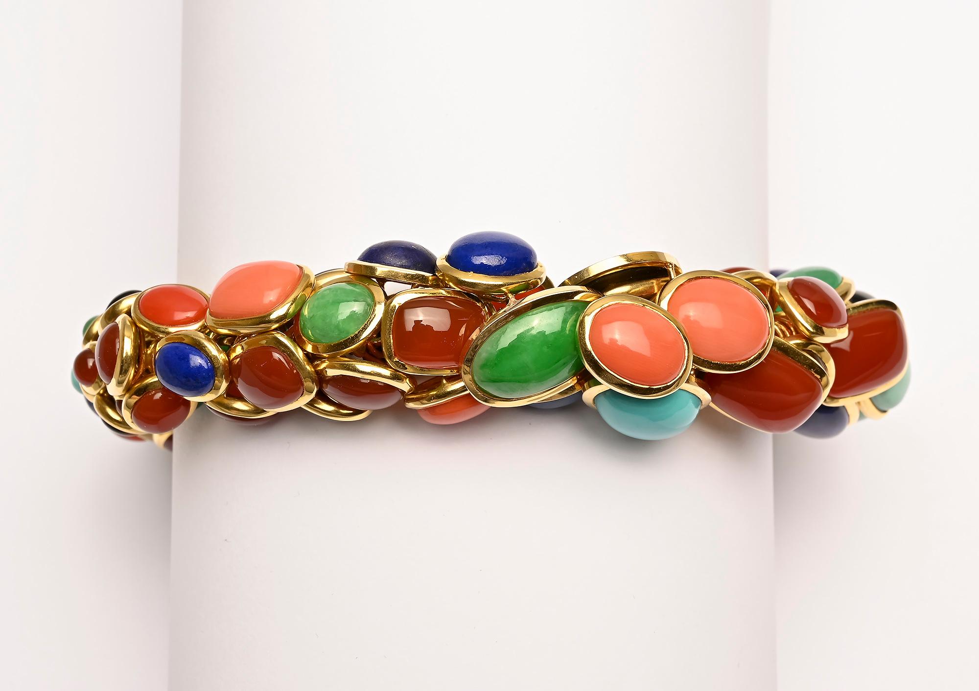 Stunning and most unusual multistone bracelet by Seaman Schepps. Lapiz lazuli; coral; cat's eye; jade; onyx and carnelian are set in round, oval and rectangular bezels creating a rounded form. When closed, the inner  diameter is 2 1/2 inches. The