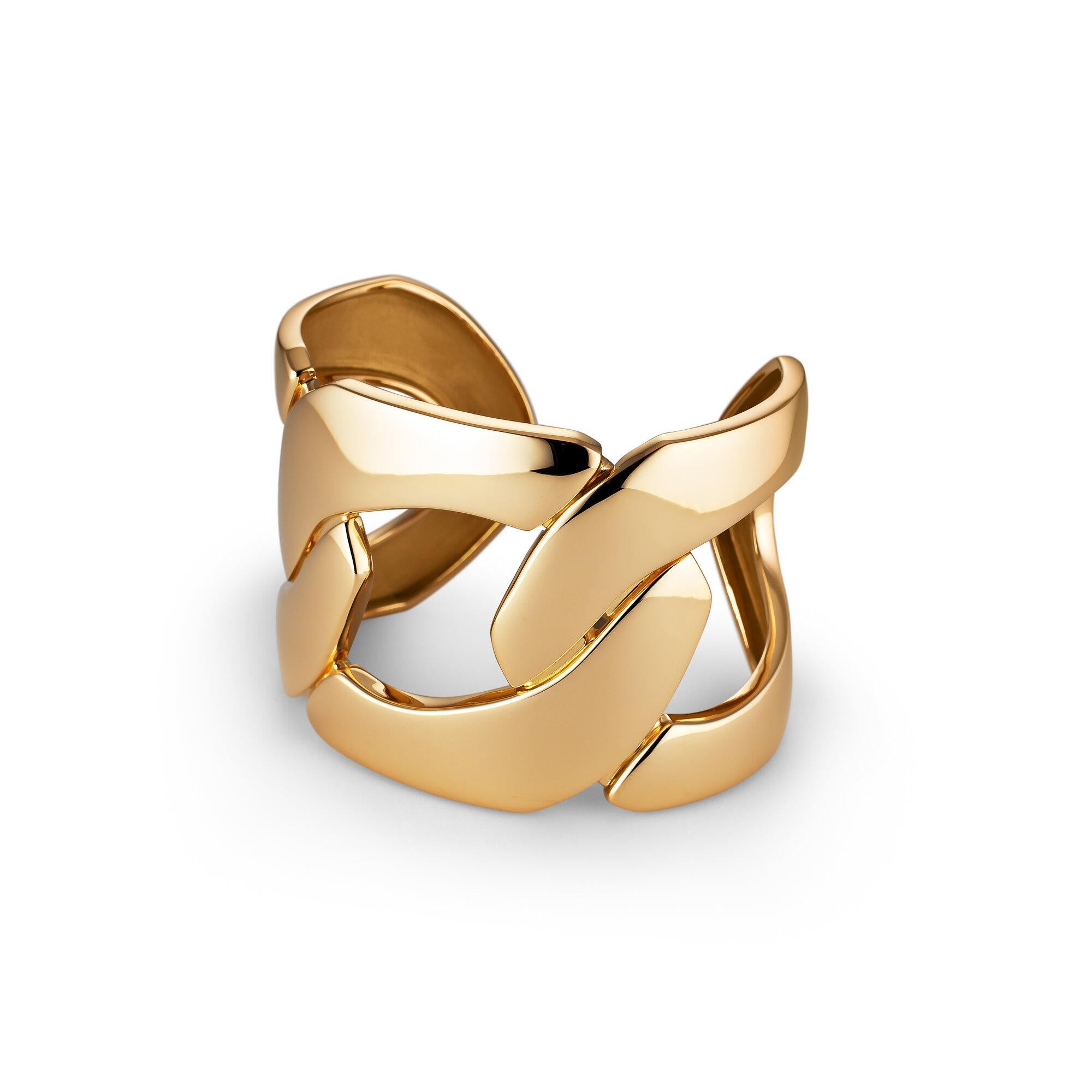 You will be forever linked-in when wearing this chunky Seaman Schepps yellow gold cuff.  With three intertwined and oversized links, this statement cuff is a chic and architecturally strong modern accessory.  18 karat gold.   Seaman Schepps