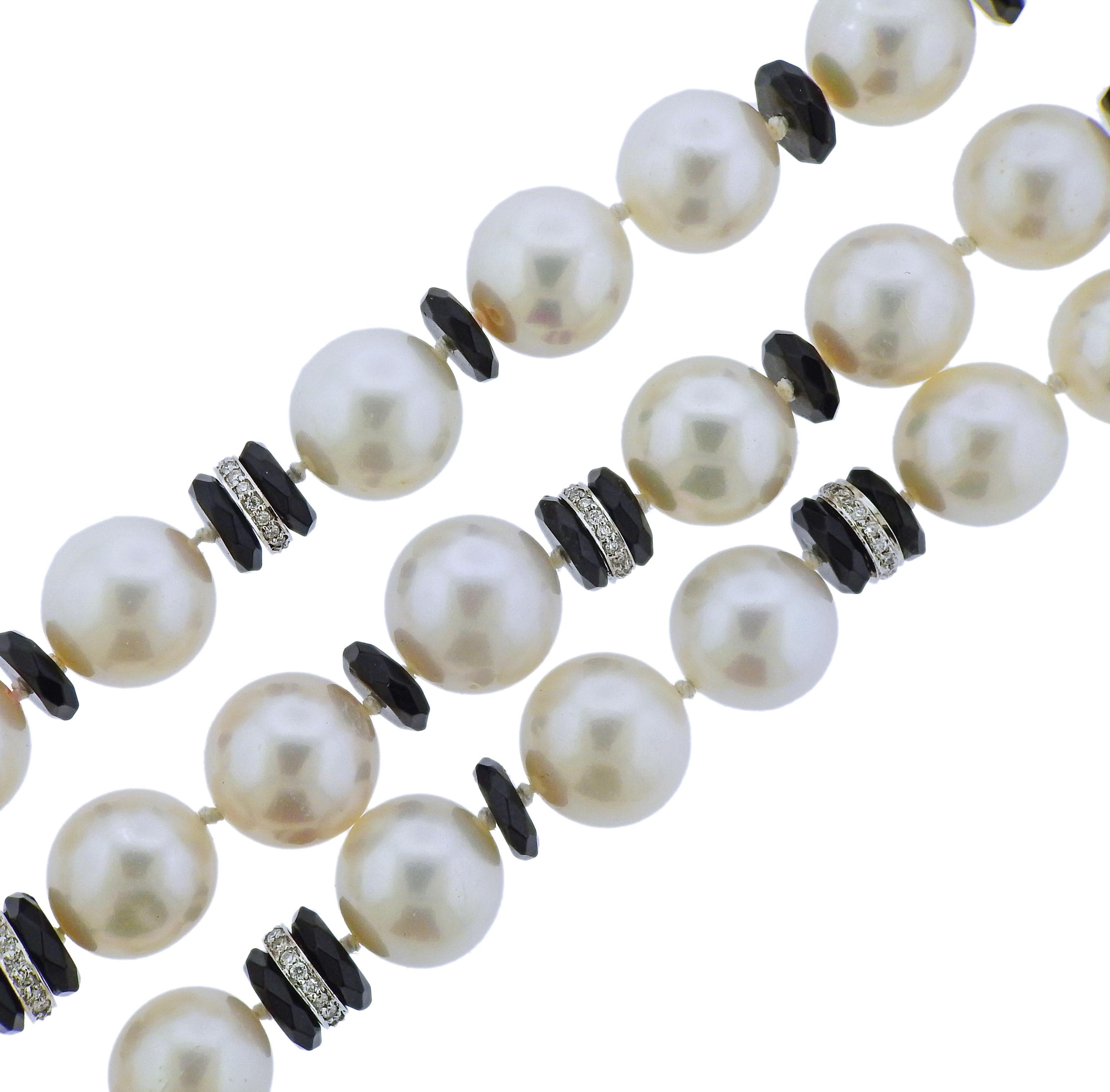 18k gold multi strand bracelet by Seaman Schepps, featuring onyx, approx. 0.80ctw in G/VS diamonds and 11 - 13mm pearls. Retail $19250. Bracelet is 8