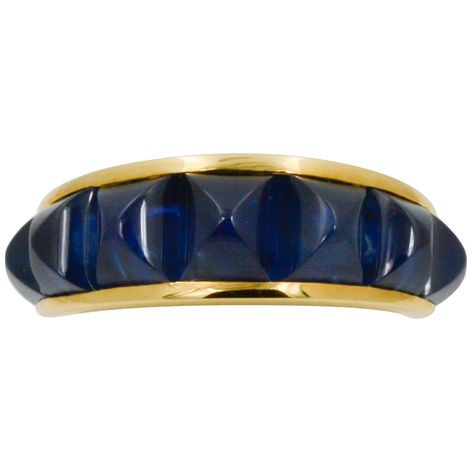 From Seaman Schepps, this 18 karat yellow gold Portofino ring features seven faceted blue sapphires weighing an approximate combined 7.81 carats. The ring is a size 8, and can be sized one (1) size up or down.