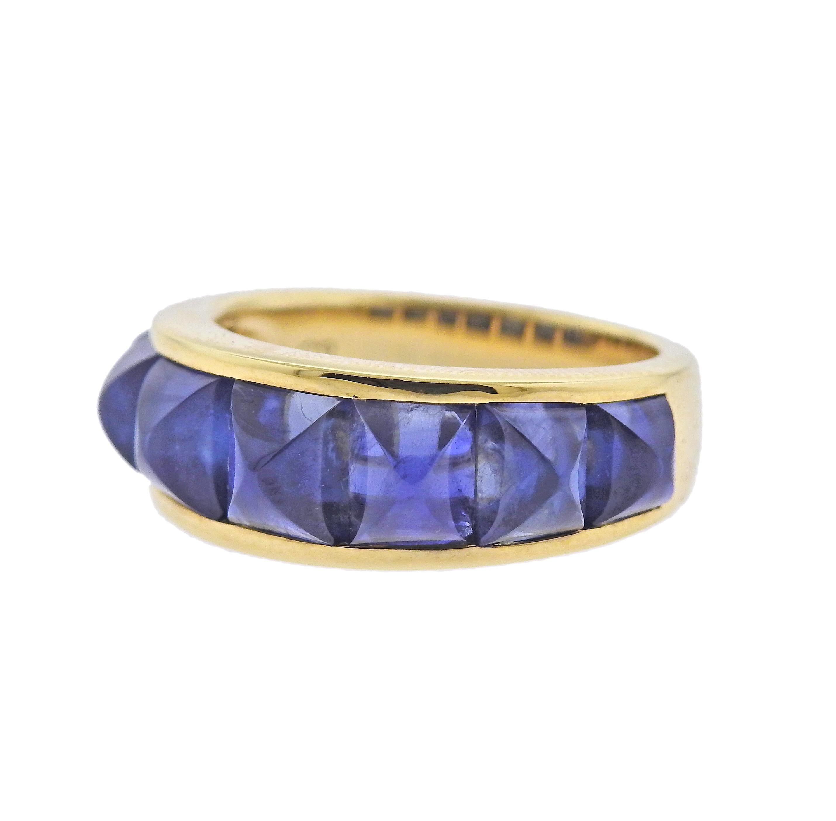 Brand new Seaman Schepps Portofino ring featuring sugarloaf blue sapphires. Ring size 8.25, width of the ring is 8.5mm. Marked: Shell mark, 750,245986. Weight is 9.6 grams.