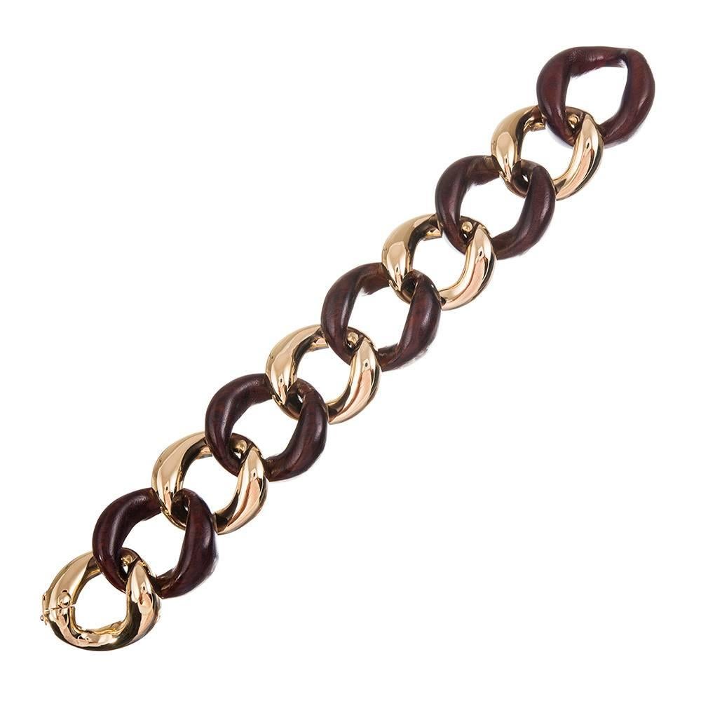An instant classic, compliments of iconic jewelry designer Seaman Schepps. Hand carved links of rosewood alternate with identical links of 18k yellow gold, embracing the classic mid-century aesthetic that is forever chic. Further the impact and wear