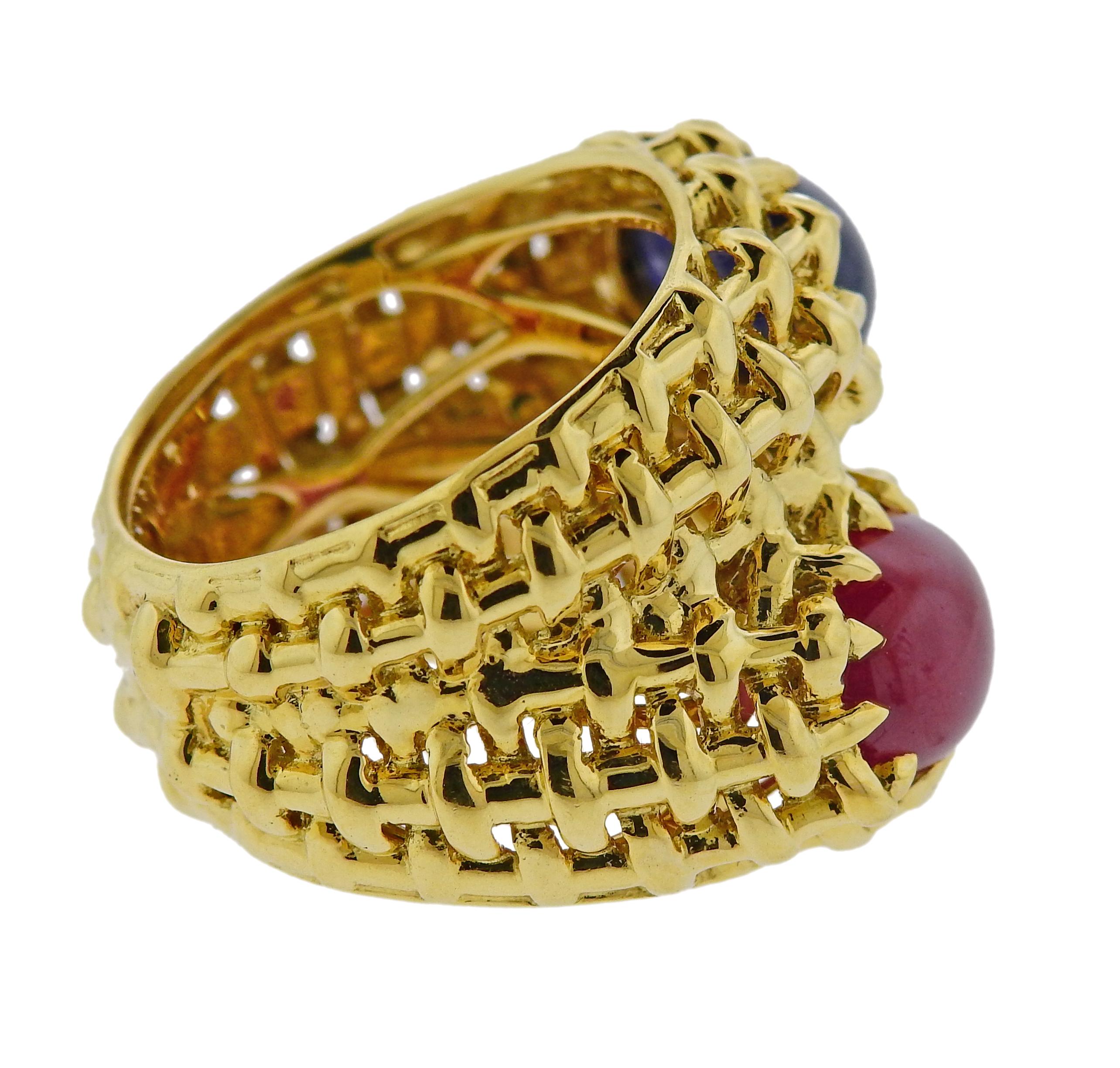 18k yellow god bypass ring by Seaman Schepps, featuring 10.5mm x 7.2mm sapphire and 10.7mm x 7.3mm ruby cabochons. Ring size - 7.5, ring top is 20mm wide, weighs 15.1 grams. Marked: 750, Shell hallmark. 
