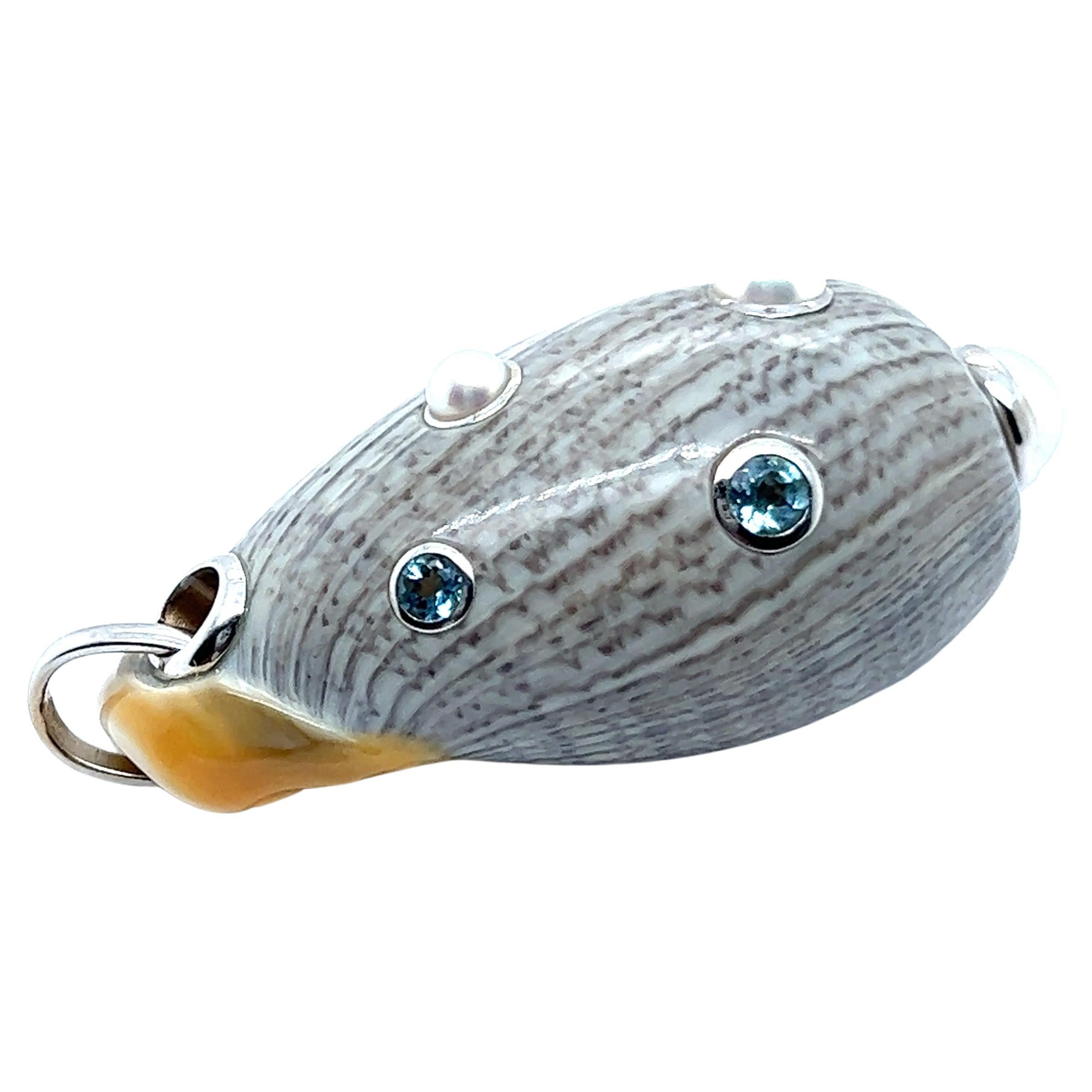 Playful pendant, stunning piece of jewelry created by the legendary designer Seaman Schepps. Created with captivating seashell in a beautiful shade of grey and 18 Karat white gold, pendant is skillfully inlaid with four exquisite aquamarines and