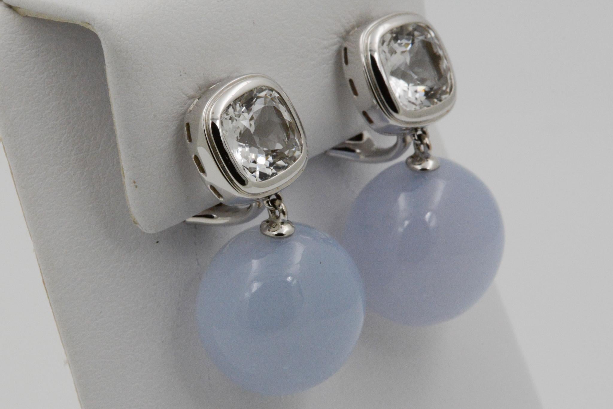 From Seaman Schepps, this Soho drop earring features bezel set cushion shape white topazes at the top of the earring and blue chalcedony round beaded drops (48.81ctw). Signed Seaman Schepps. 