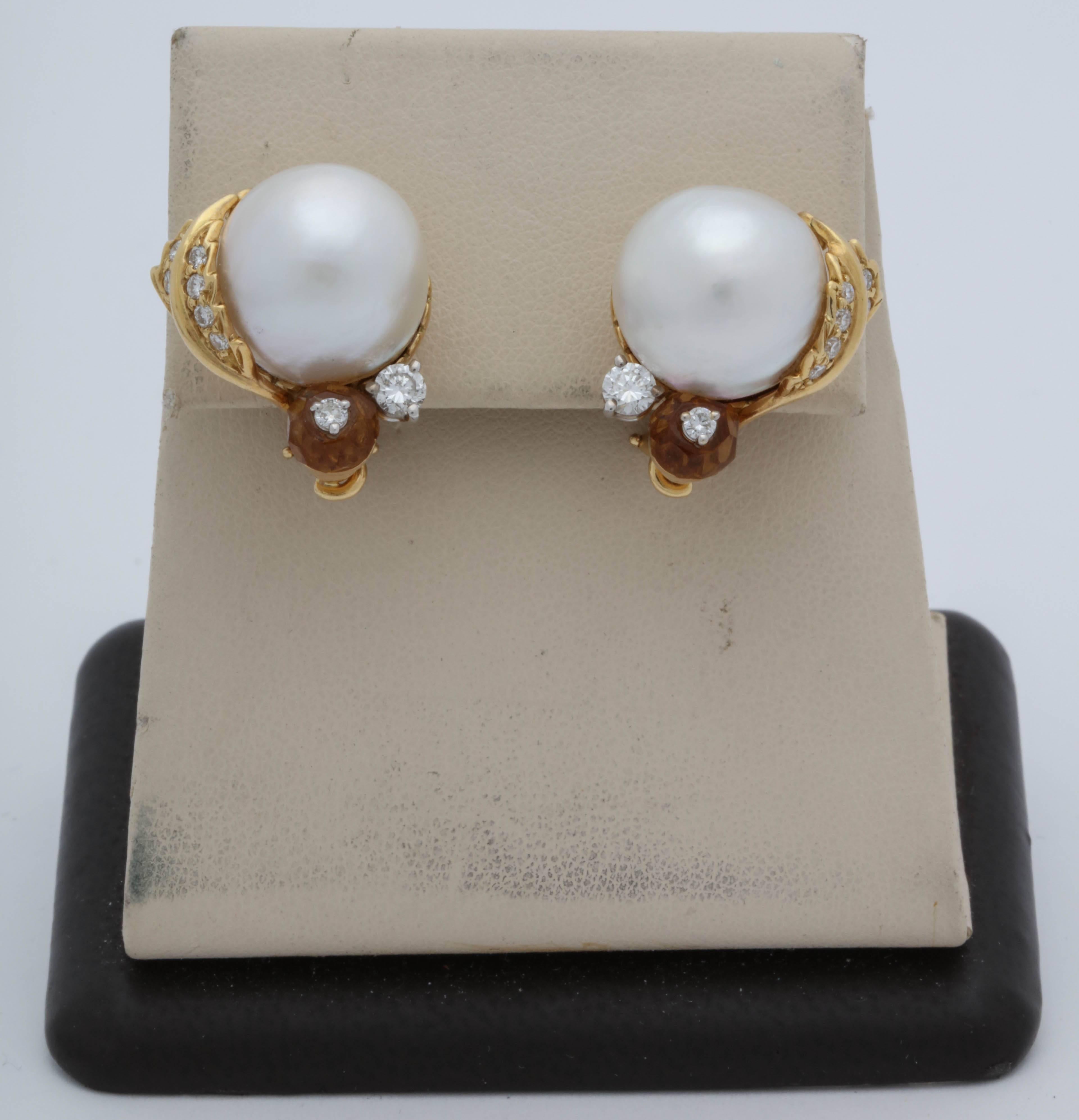One Pair Of Ladies Large South sea Pearl earrings Centering A 13MM Large Beautiful Quality South Sea Pearl. Earclips Are Further Designed With A Briloote Cut Faceted cut Citrine With diamonds In Center Of The Citrine. Earrings Are Further Designed
