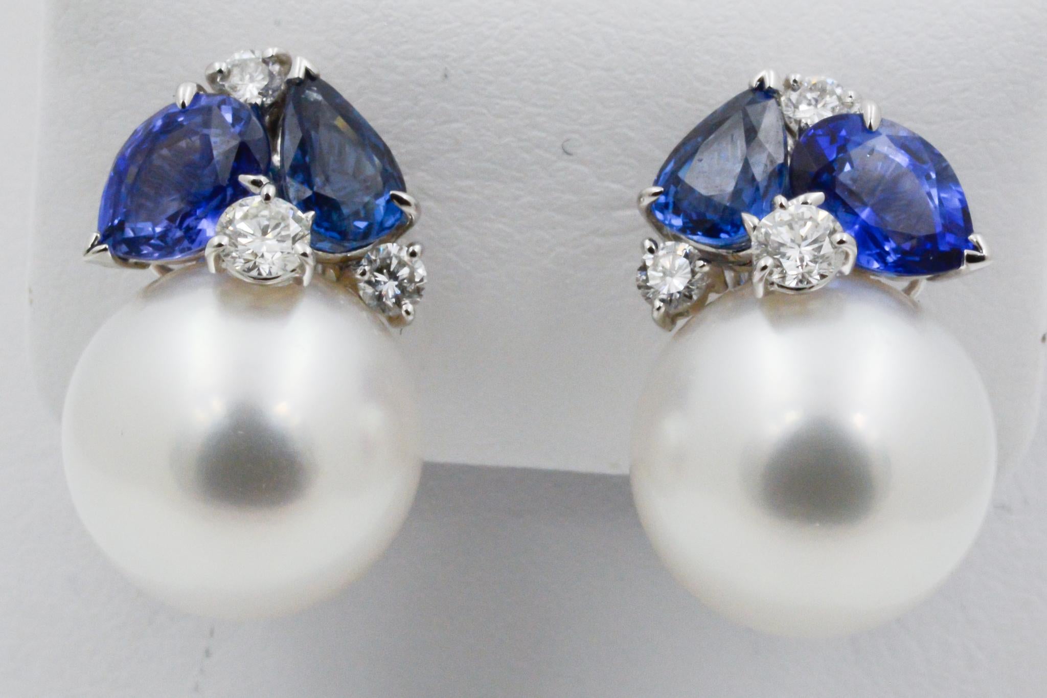 From Seaman Schepps, these 18k white gold feature 14mm white south sea pearl and four pear shaped blue sapphires (4.07ctw) and six round brilliant cut diamonds (.58ctw). Signed Seaman Schepps. 


