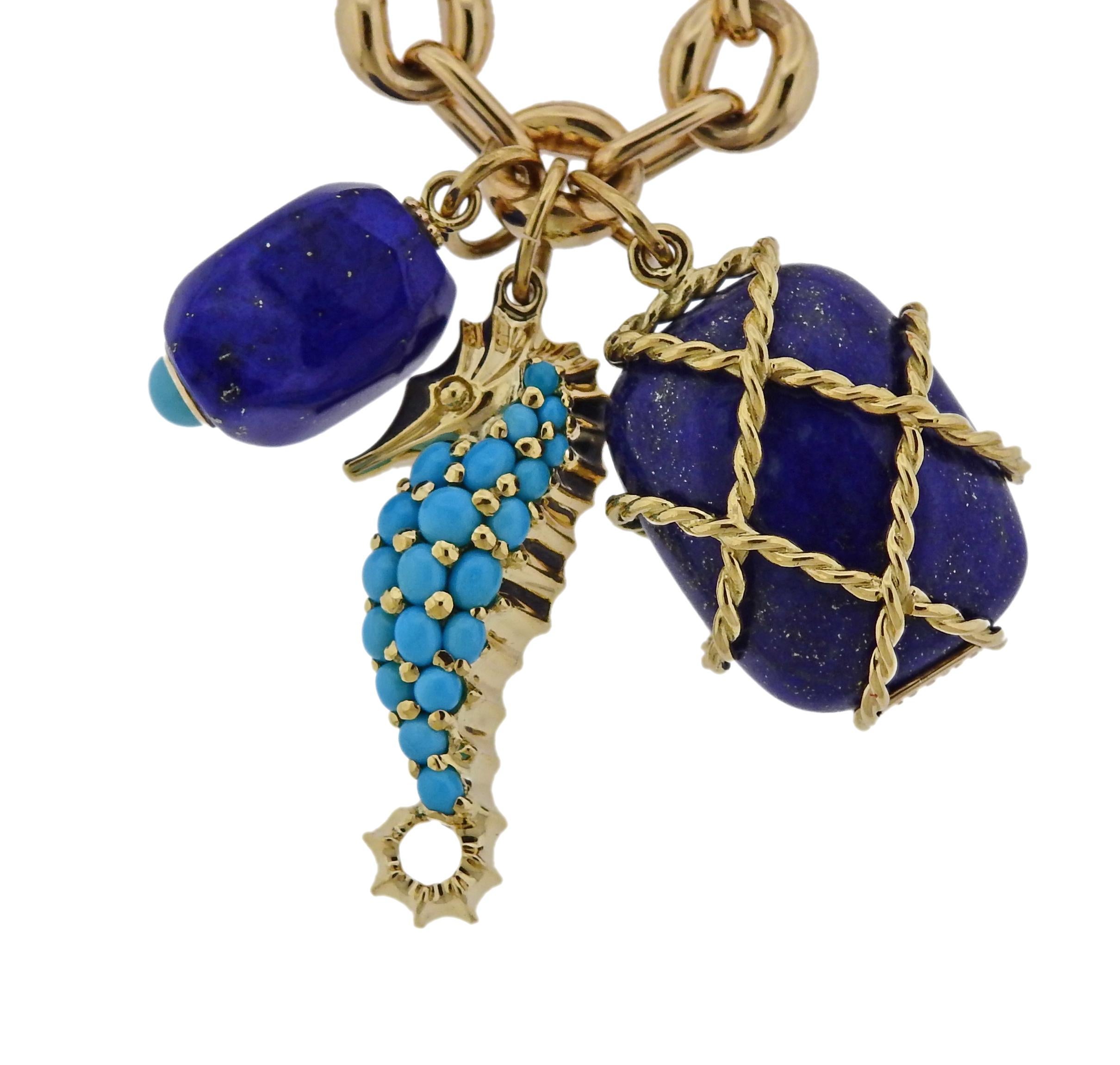 18k yellow gold long chain necklace, complimented with three charm pendants - turquoise seahorse, caged lapis and nugget pendant. All designed by Seaman Schepps.  Necklace is 31.5