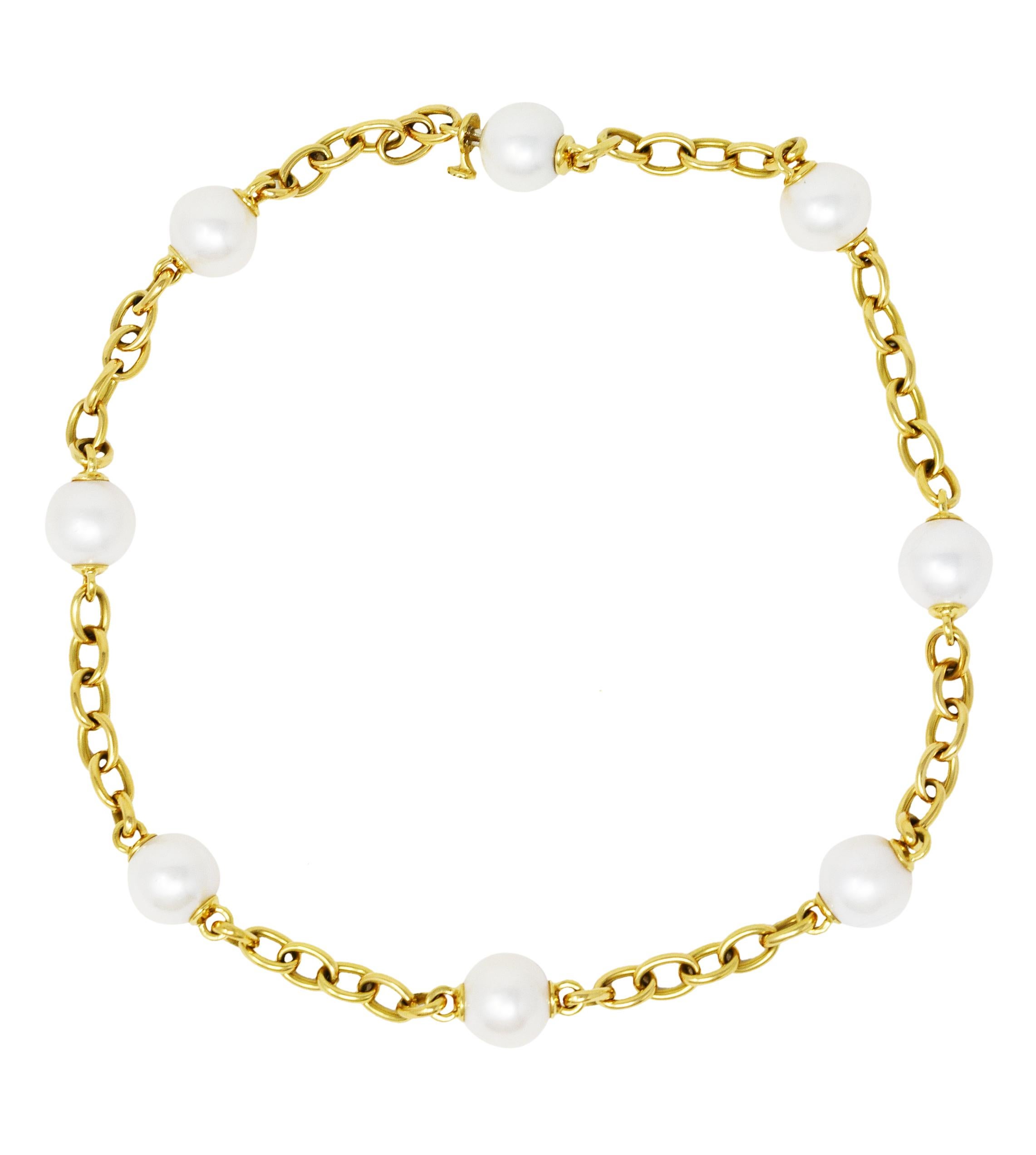 Necklace is designed as a cable chain necklace with eight 12.0 mm round South Sea pearl bead stations

White in body color with iridescence and good luster

Completed by hidden barrel clasp closure

Stamped 750 for 18 karat gold

With serial number