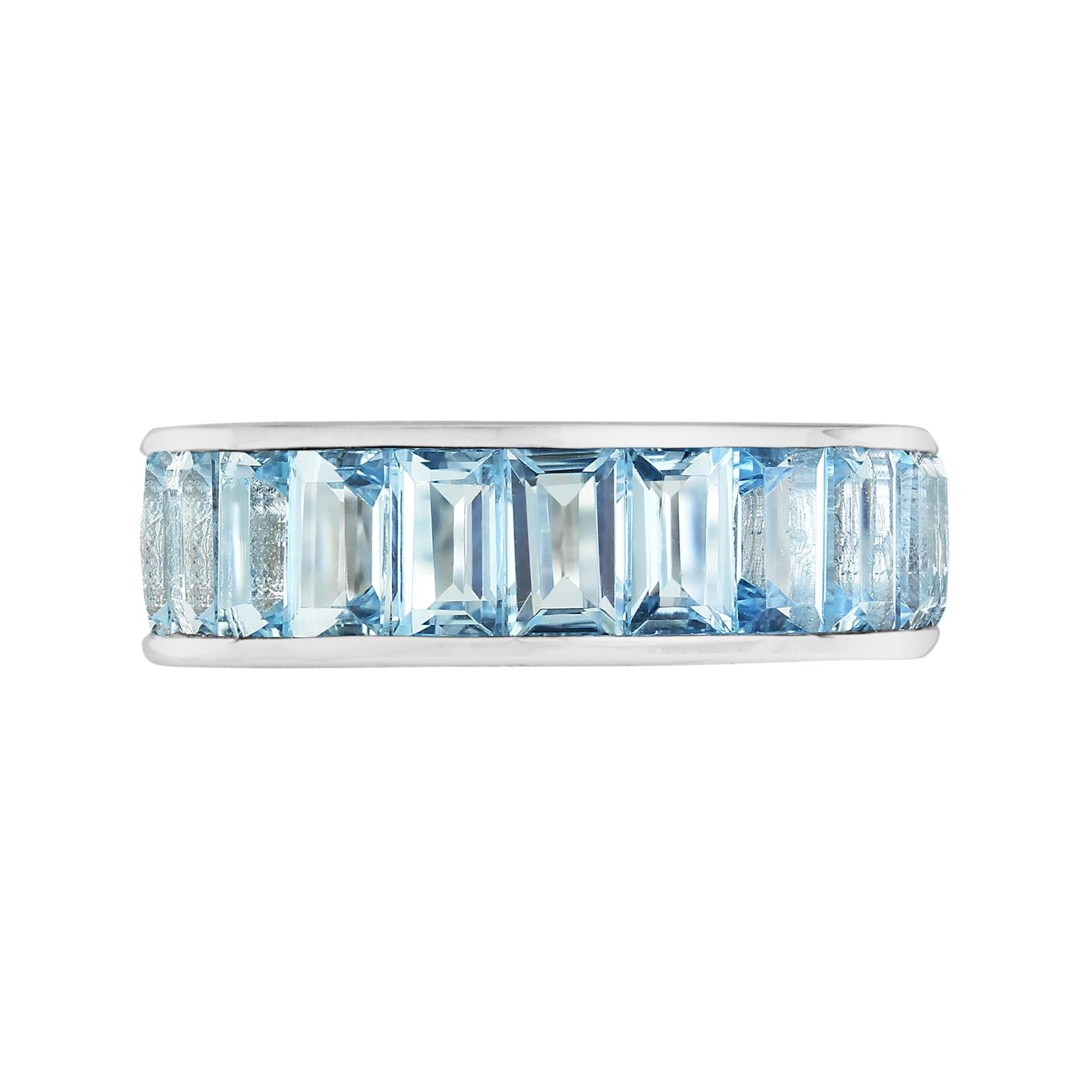 A unisex ring that can truly amp up the style of any outfit!
This blue topaz eternity band is the perfect addition to your collection. Twenty-two baguette-cut blue topaz are vertically set in 18k white gold. The ring measures 6 mm. wide so it looks