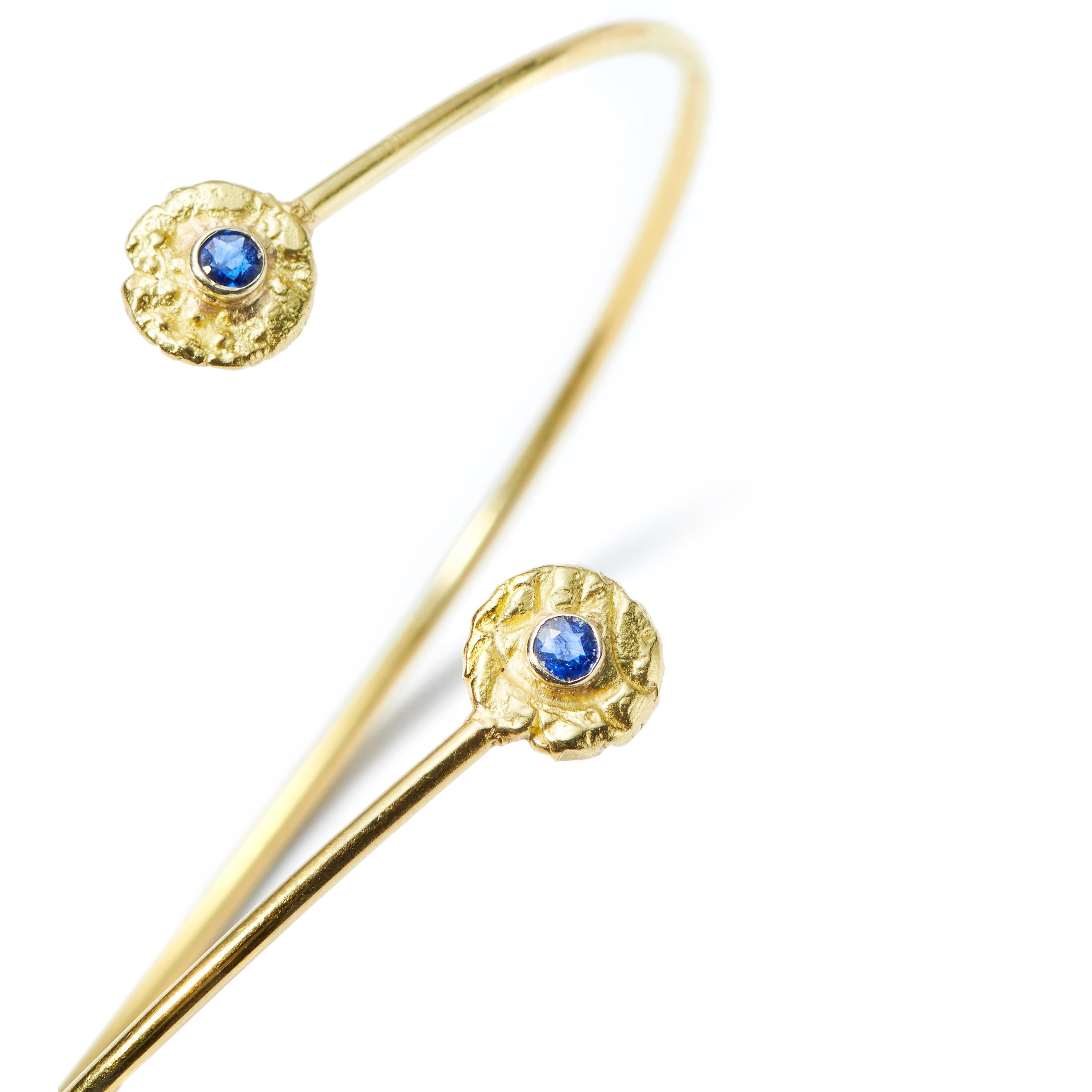A chic new design in the Susan Lister Locke Collection. Simple and classic, this 18 Karat Gold bracelet features her exclusive “Seaquins” set with Blue Sapphires.

*Please note: The last photo features the Diamond  “Seaquin” Bypass Bangle Bracelet