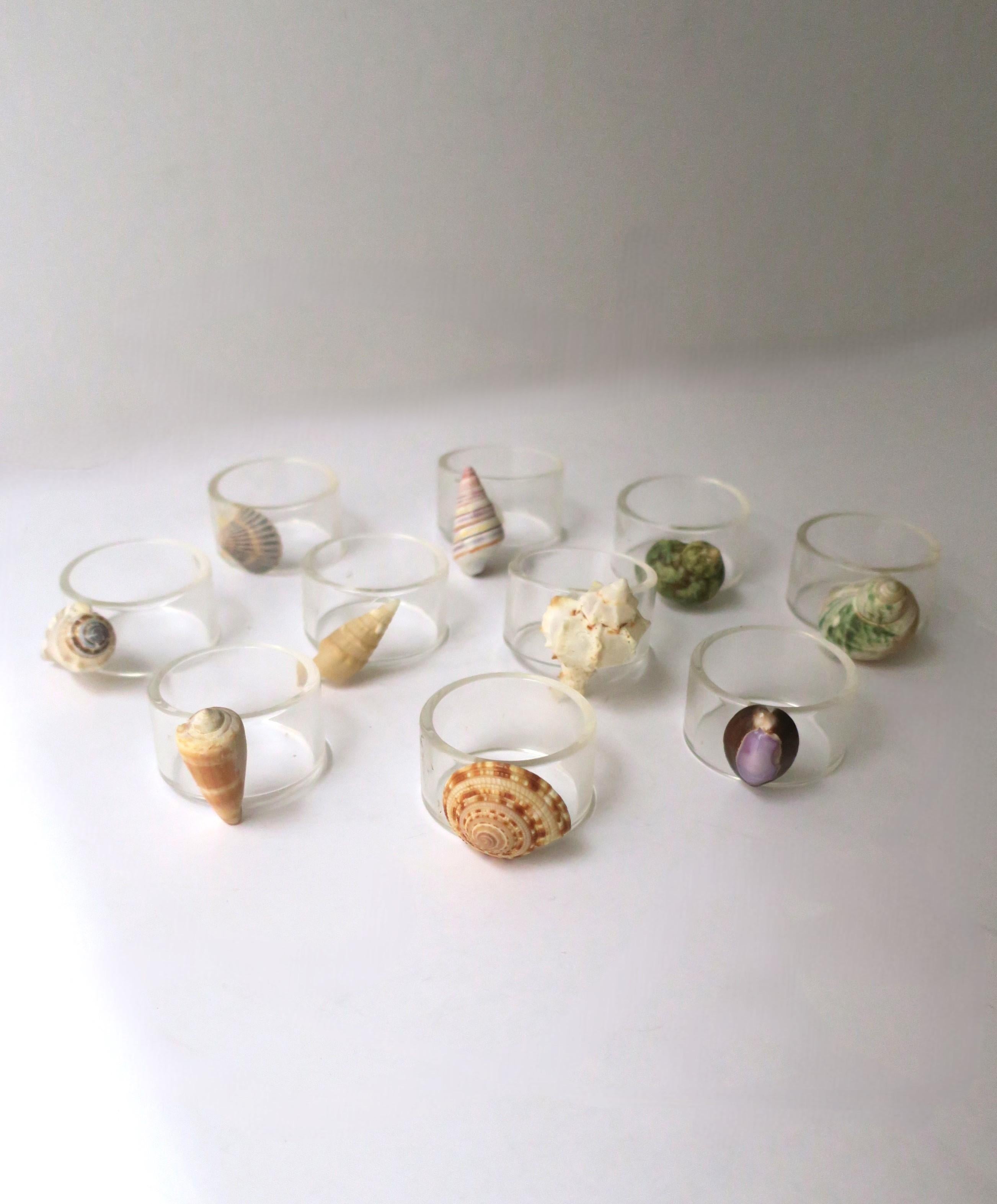 A vintage set of ten (10) seashell and Lucite napkin ring holders, circa 1960s. A different natural seashell on each ring. Very good condition as shown in images and video. 

Vintage napkins shown available separately, search 1stDibs ref. #: