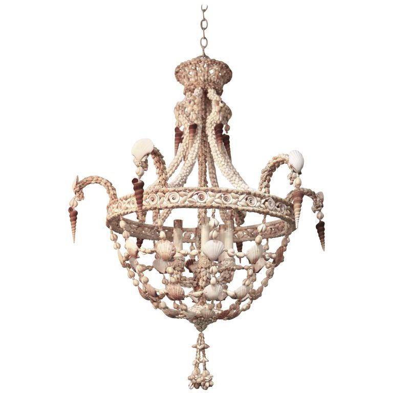 This stylish seashell encrusted chandelier is very much in the style of pieces created by Tony Duquette and the era of Hollywood Regency. 

Note: Piece requires six candelabra based bulbs.

Note: Main body of chandelier is 35