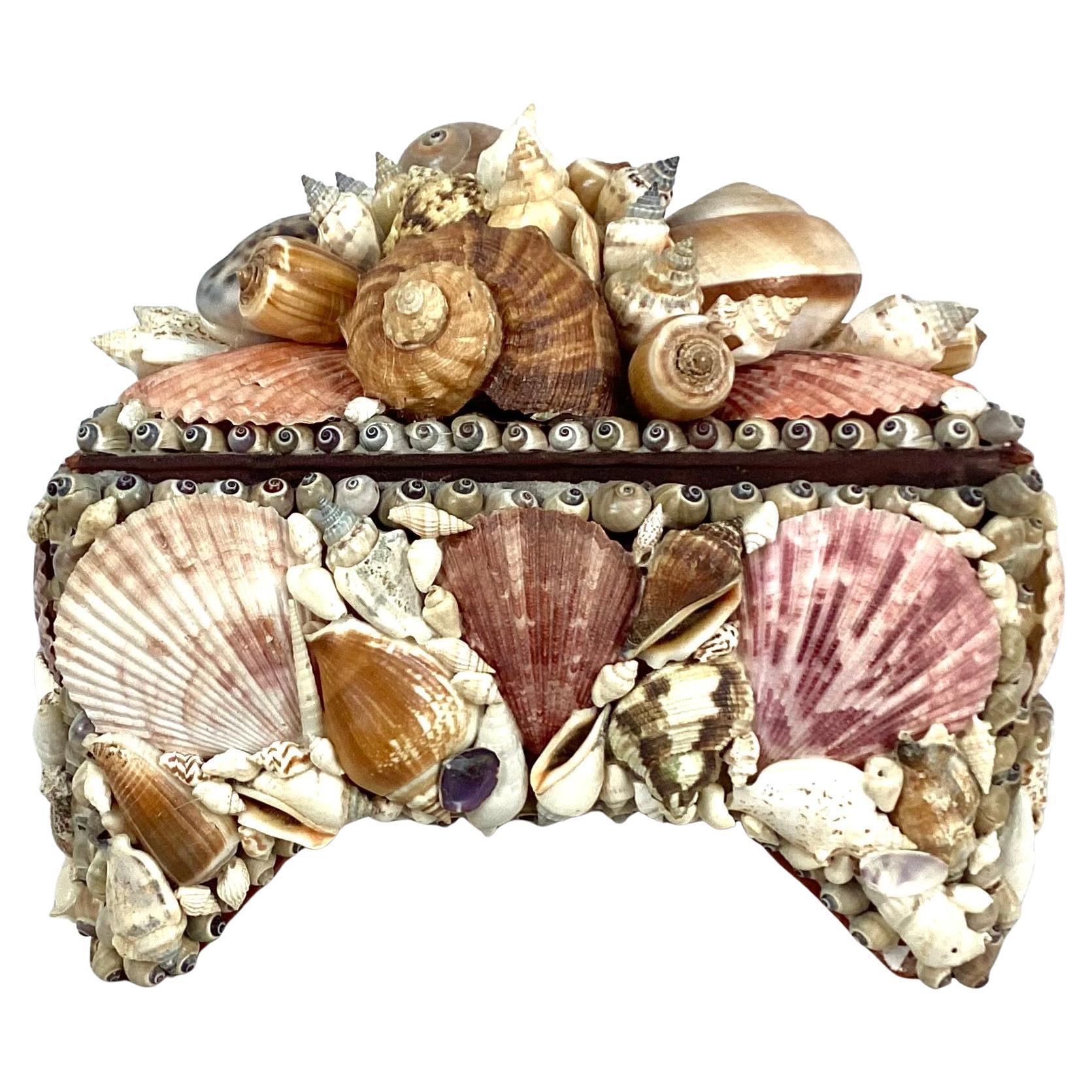 Vintage seashell encrusted jewelry box embodies the bohemian aesthetic popular during the mid- 20th century. Hand-crafted with an array of shells that embrace the eclectic, earthy and natural materials popular during this time. The shells are