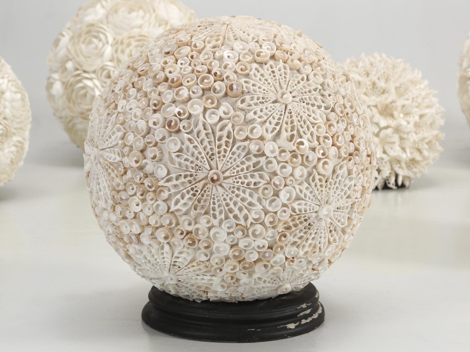 Collection of seashell encrusted spheres, which I believe are made out of fiberglass. Although we purchased this grouping, of (7) seashell lights a number of years ago in France, I am assuming that the seashells are from the South Pacific. The