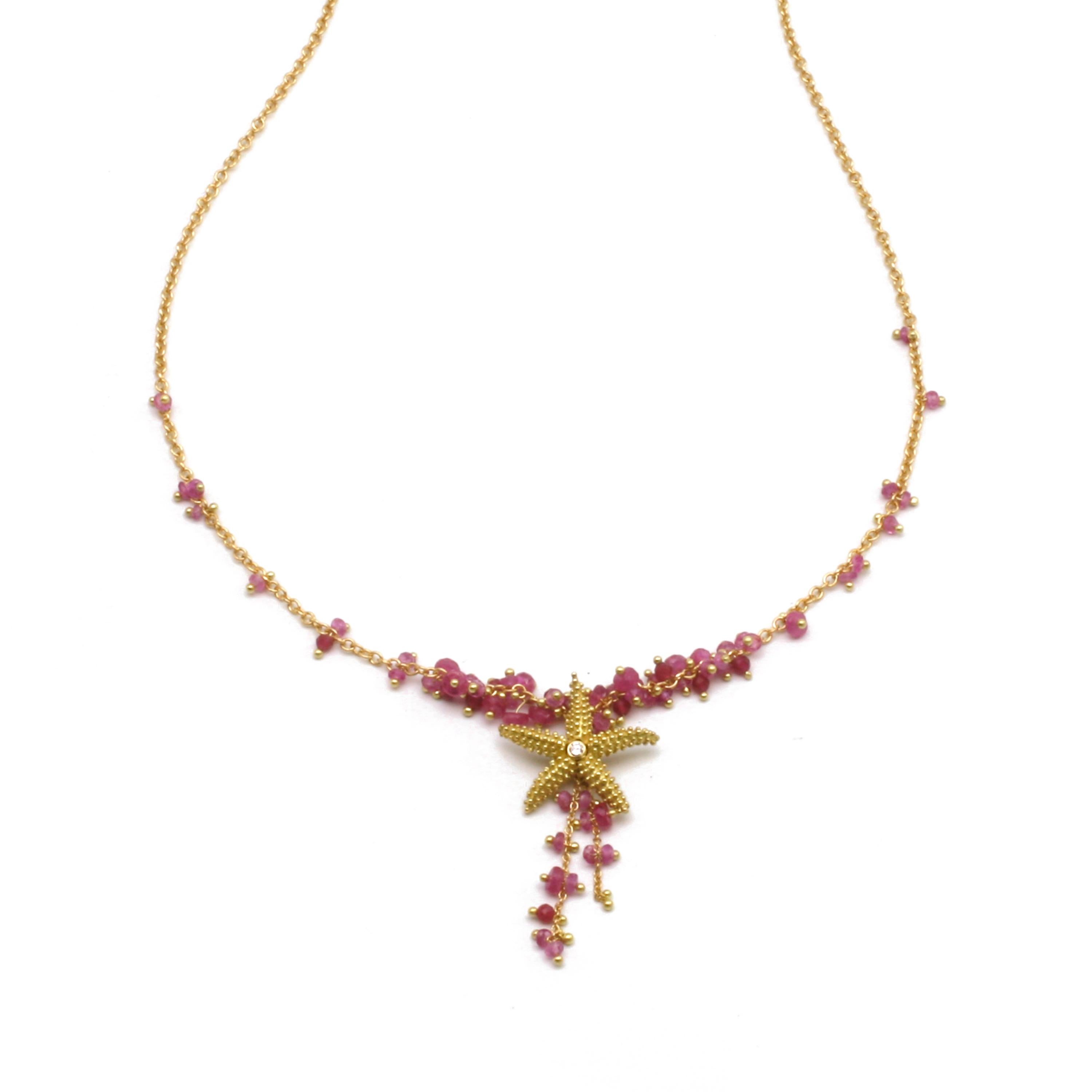 Seastar Necklace with faceted Pink Sapphire beads in 18k Gold.  17 inches. Deep Pink Sapphire beads run throughout the 18k chain that suspends the 18k sea star. Three strands of Pink Sapphire beads cascade down from the solid gold sea star. Can be