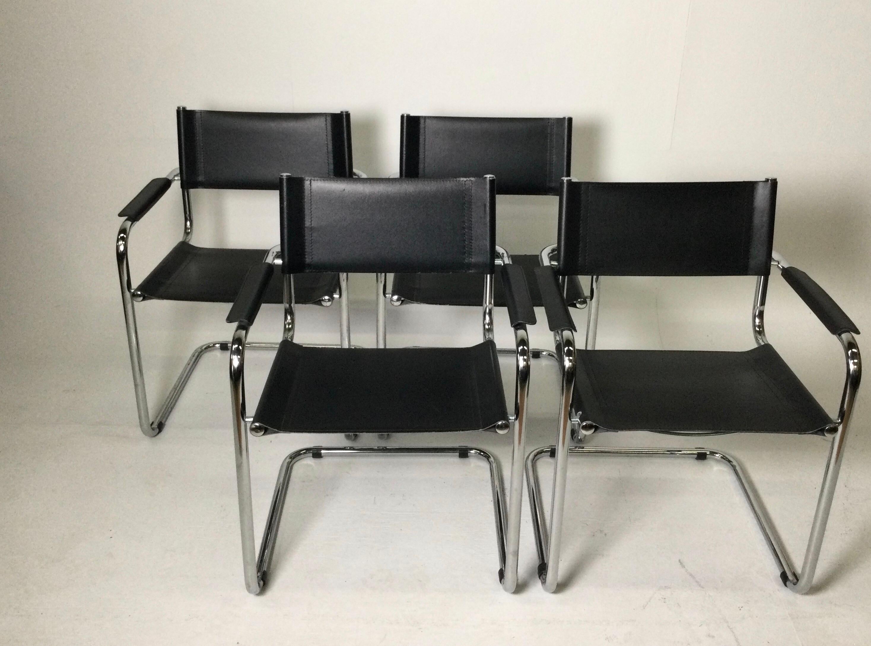 Setof 4 black leather chrome plated tubular steel Cantilever style arm chairs. Some still have paper labels on bottom. All marked Made in Italy on the underside of seat. Some age appropriate wear from use. Some light rust on the bottom chrome legs.