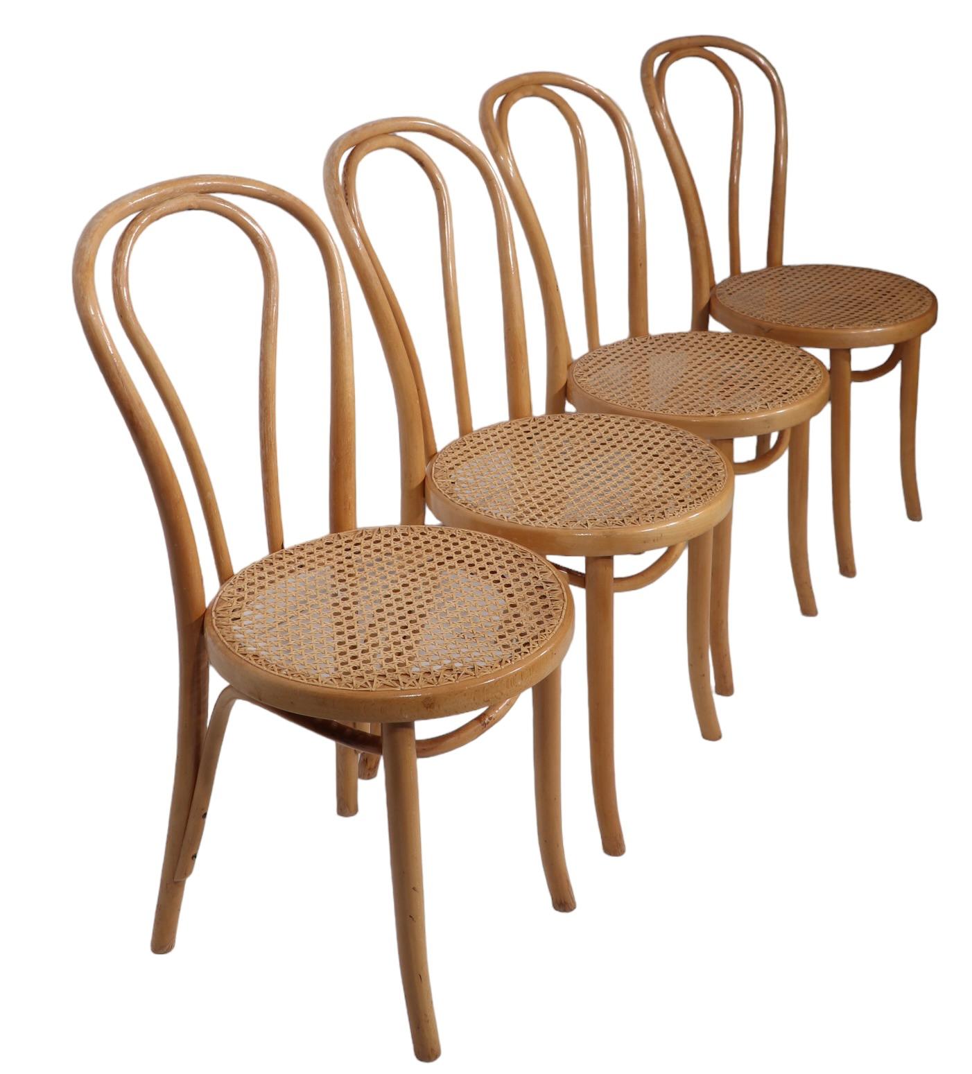 Stylish set of bentwood chairs, in the Vienna Secessionist style, marked FMG. The chairs are in original, and unusual, blonde finish, with original caned seats. Attributed to Thonet, unsigned.  All are structurally sound, sturdy and ready to use, 