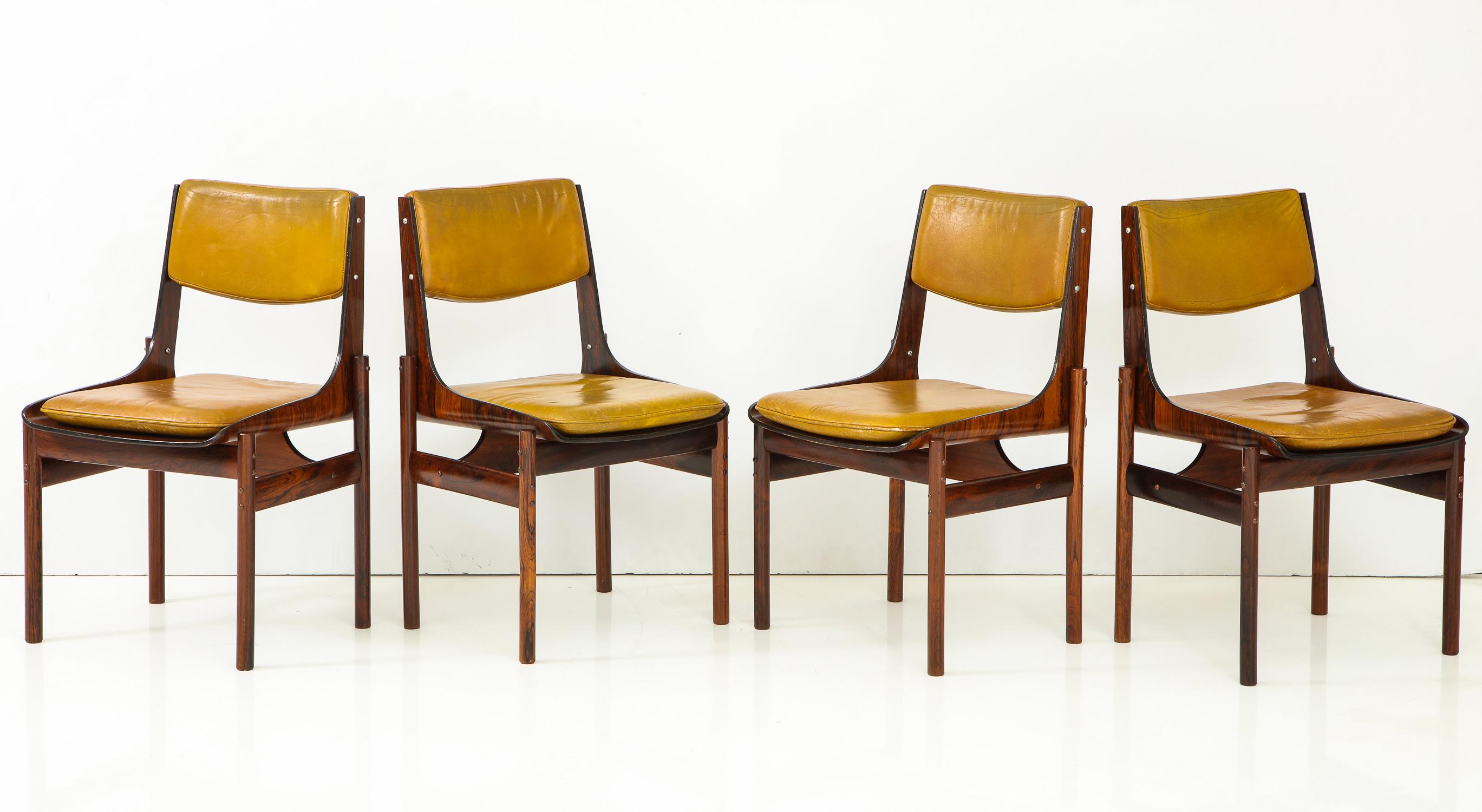 Set of four dining chairs in Jacaranda and Jacaranda plywood with original yellow ochre leather back cushions and loose seat cushions. Made in Sao Paulo, Brazil, circa 1965 by J.D. Moveis e Decoracoes in a style inspired by Jorge Zalszupin. With one