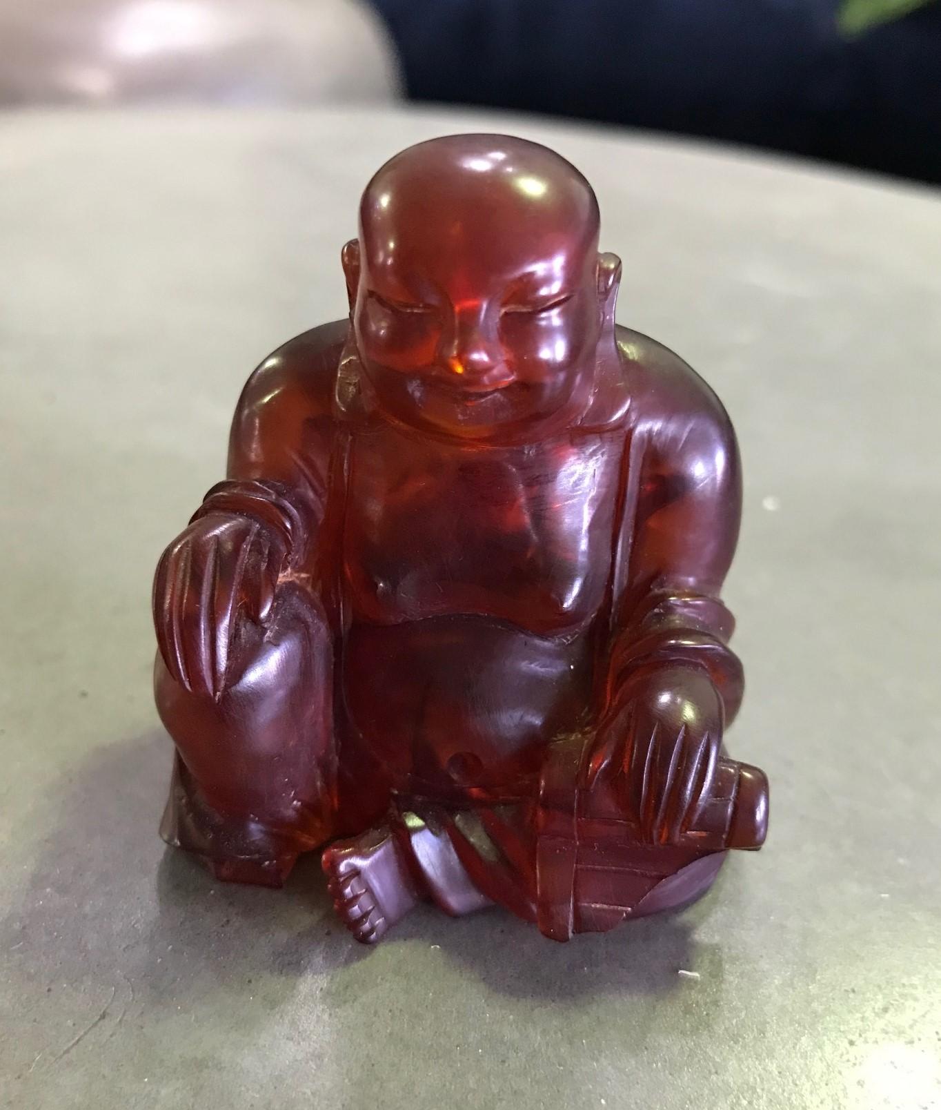 A pleasantly happy and serene pocket-sized seated Buddha. Nice details. Beautiful feel to it. 

Would make for a nice addition to any Asian art or artifacts collection or a very eye-catching stand-alone work.

Dimensions: 2