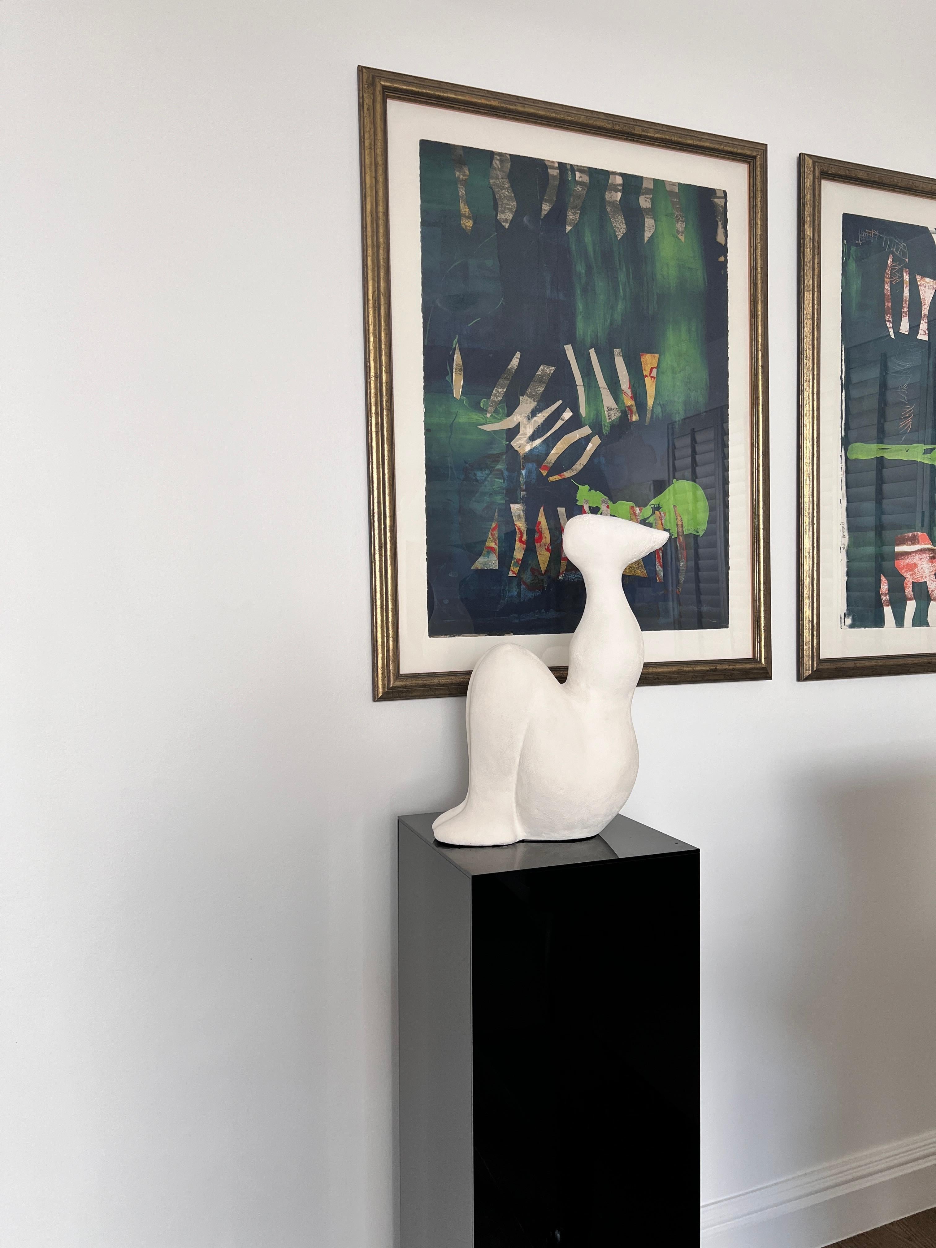 
An abstract sculpture of a seated figure in white,  handcrafted molded and cast in full bodied gypsum reinforced with fibreglass matting. The creative process takes multiple stages, from sculpting the original piece followed by molding, casting in