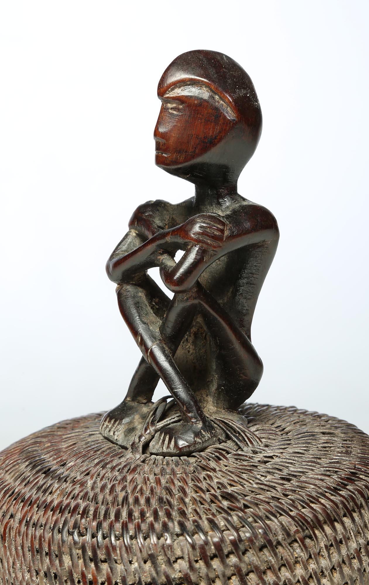 Tribal Seated Philippine Miniature Bulul Figure Sitting on Old Hat or woven Basket Top For Sale