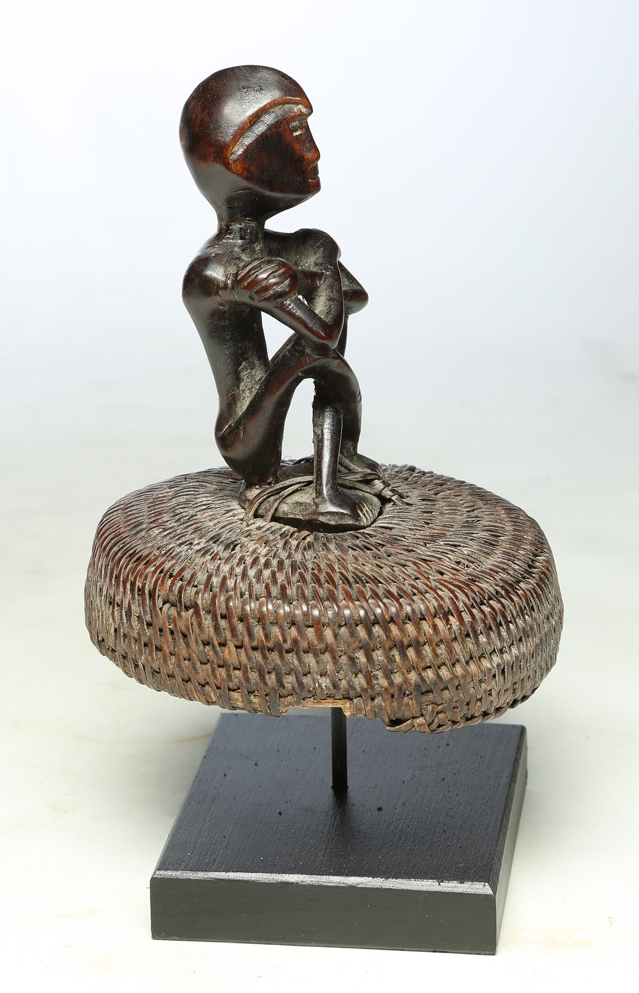 Seated Philippine Miniature Bulul Figure Sitting on Old Hat or woven Basket Top In Fair Condition For Sale In Santa Fe, NM