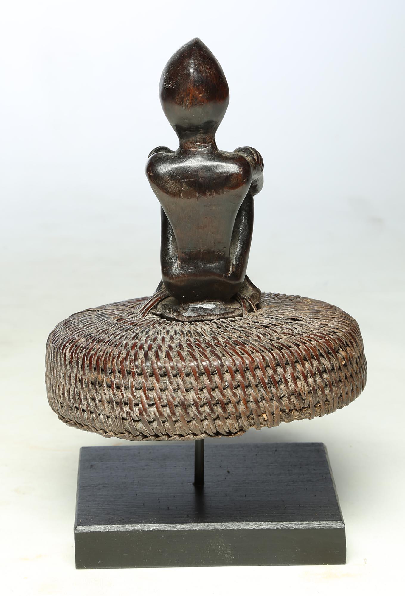 20th Century Seated Philippine Miniature Bulul Figure Sitting on Old Hat or woven Basket Top For Sale
