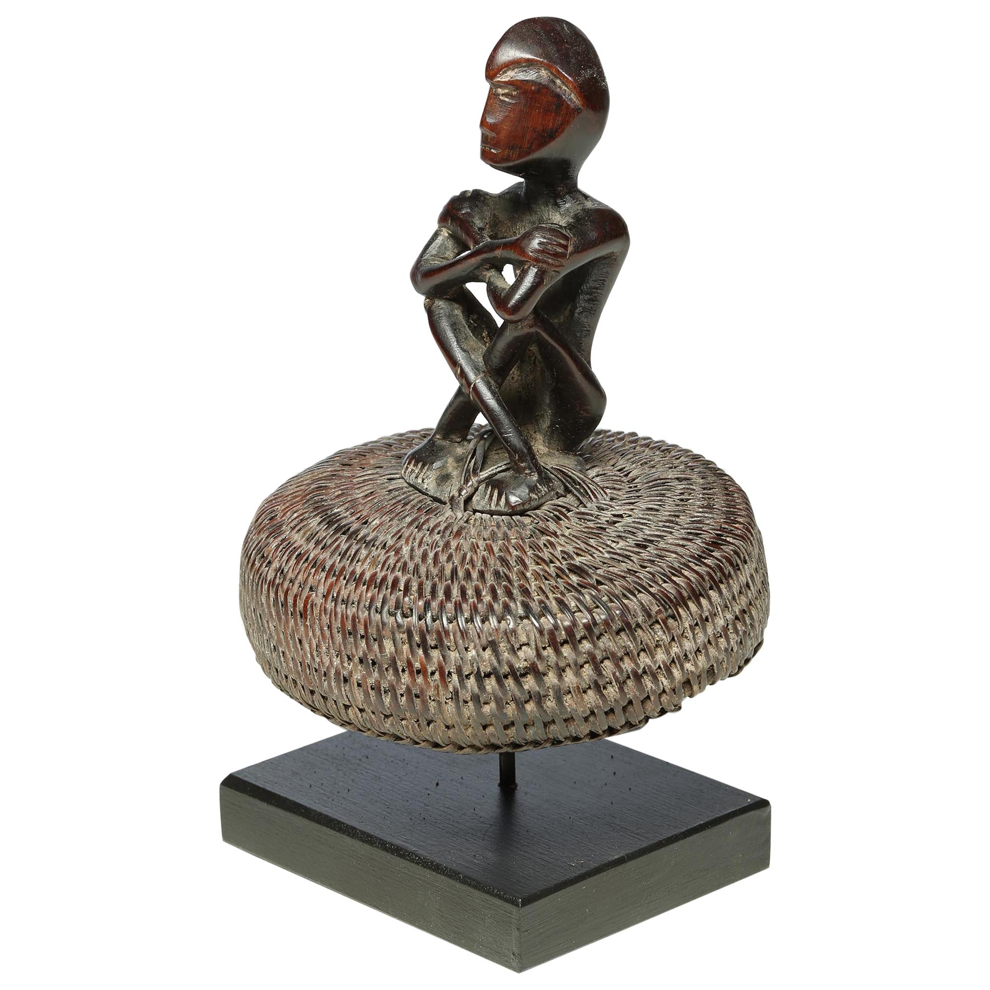 Seated Philippine Miniature Bulul Figure Sitting on Old Hat or woven Basket Top For Sale