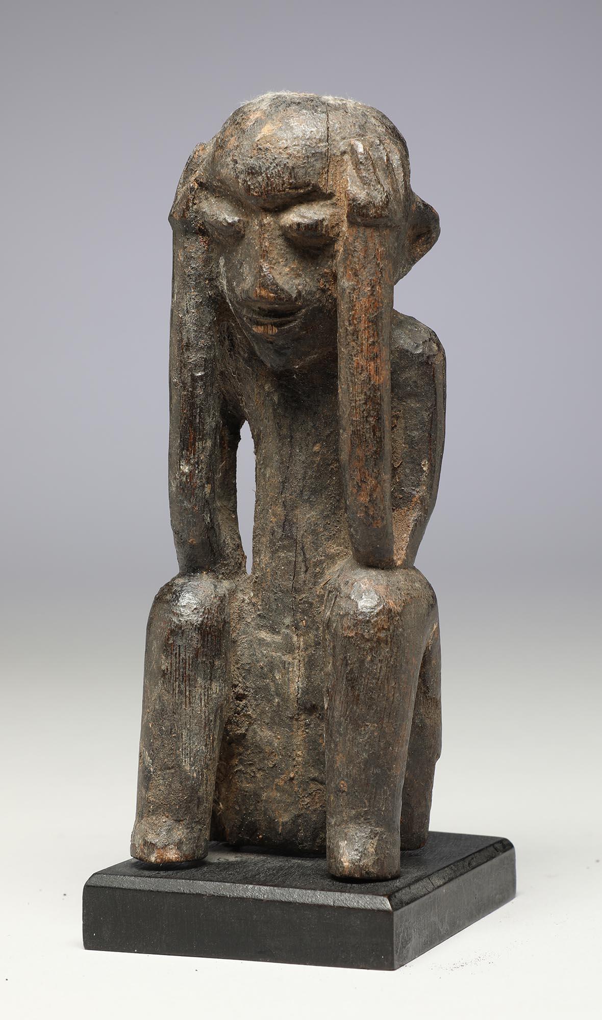 Seated Philippine Miniature Bulul Figure with Hands on Side of Head, Eroded In Fair Condition For Sale In Santa Fe, NM