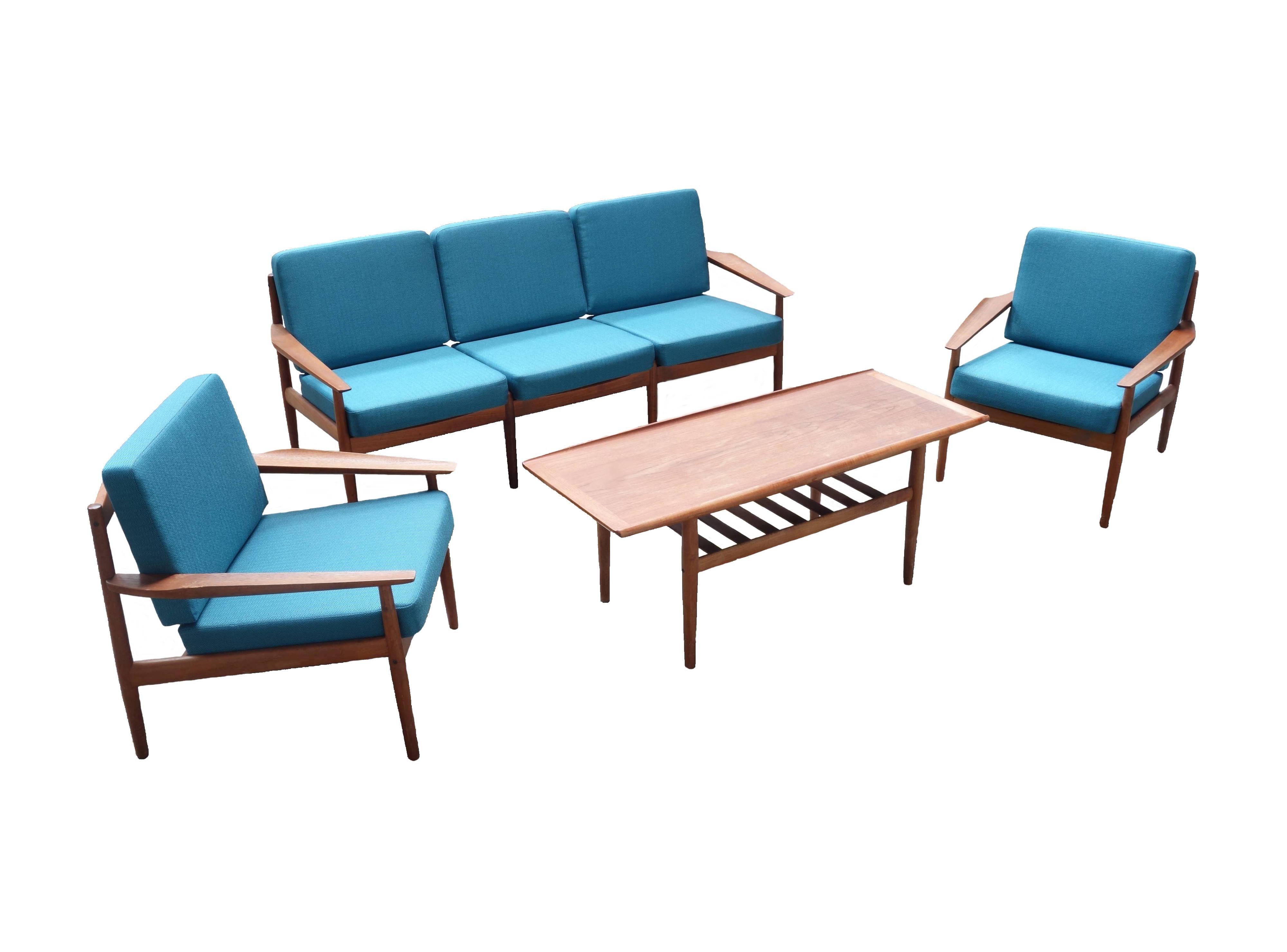Complete and original living room set consisting of two armchairs, one sofa and a coffee attributed to Grete Jalk for Dansk Mobler, Denmark, 1960s. Solid teak wood frames with completely new padding and cover fabric in accurate reference to the