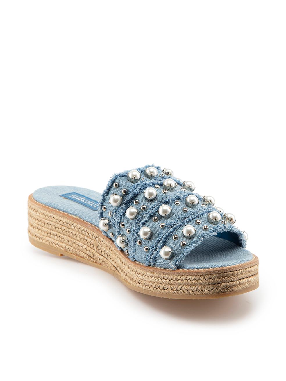 CONDITION is Good. Minor wear to shoes is evident. Light wear to both shoes with loose pearls and one missing embellishment on the right shoe on this used Sebastian designer resale item.
 
Details
 Blue
Denim
Slides
Platform
Open toe
Pearl and stud