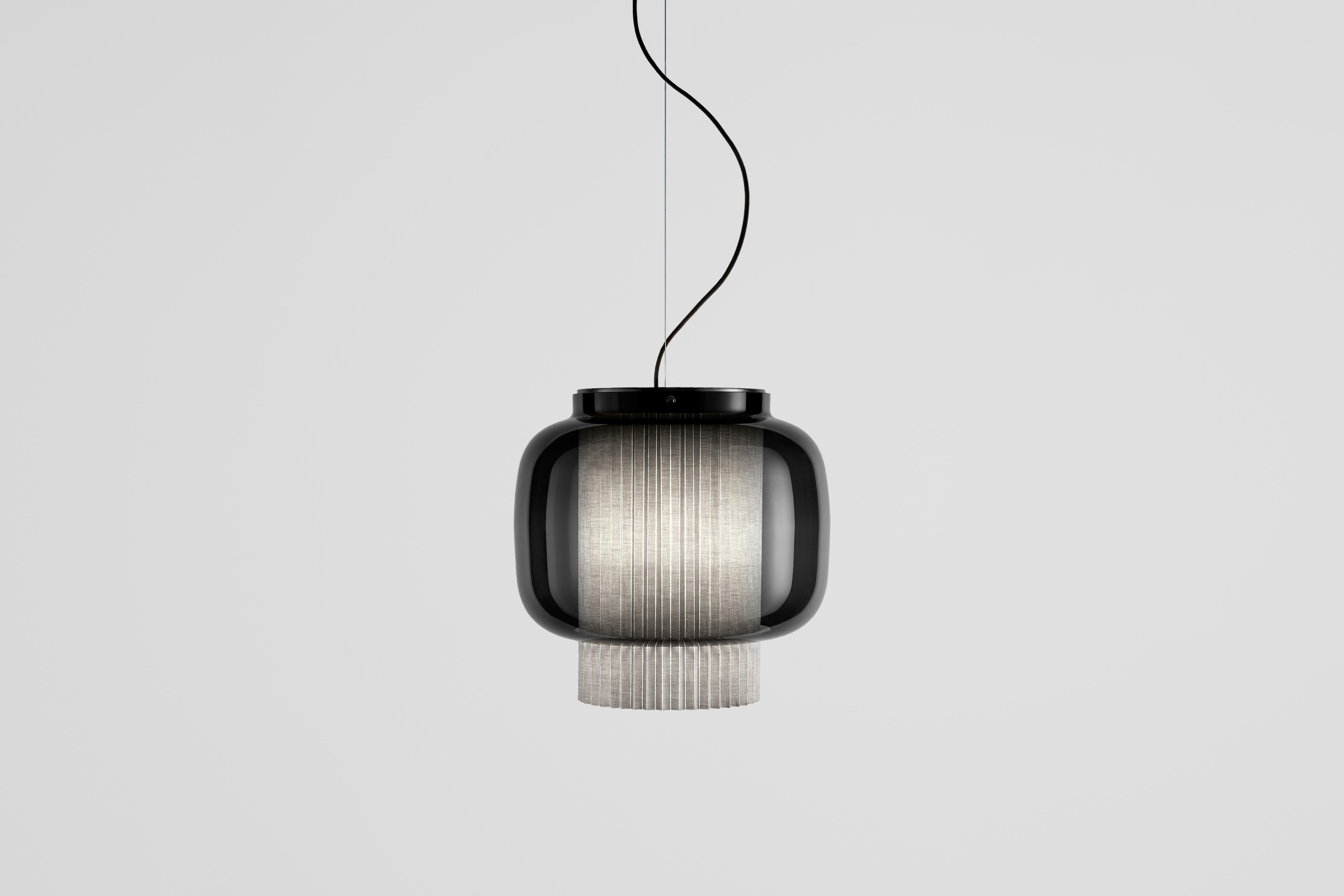 Manila T GR by Sebastian Herkner


An incredibly elegant combination of artisanal blown glass and a plissé textile diffuser. Its name comes from Spanish 