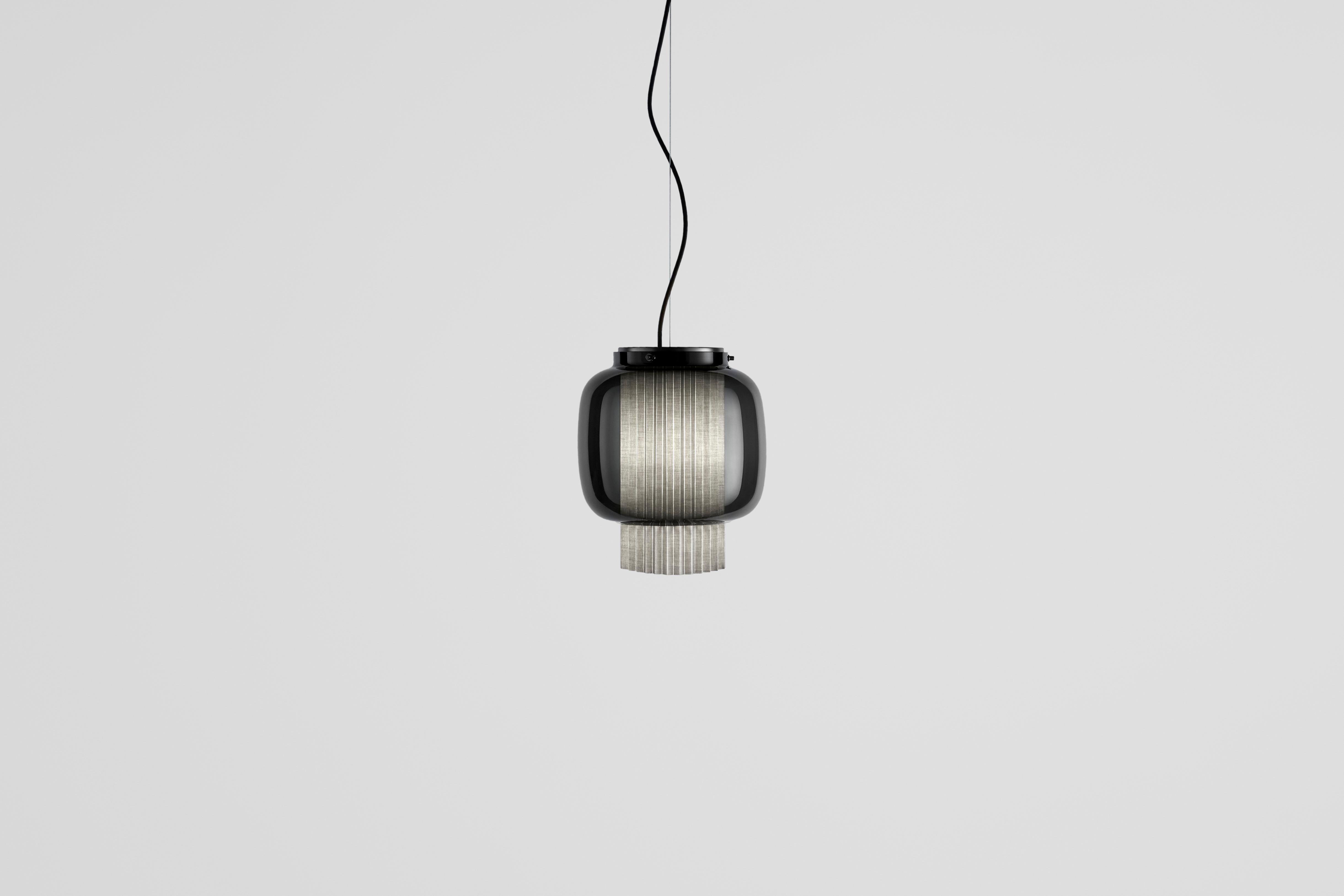 Manila T PE by Sebastian Herkner
An incredibly elegant combination of artisanal blown glass and a plissé textile diffuser. Its name comes from Spanish 