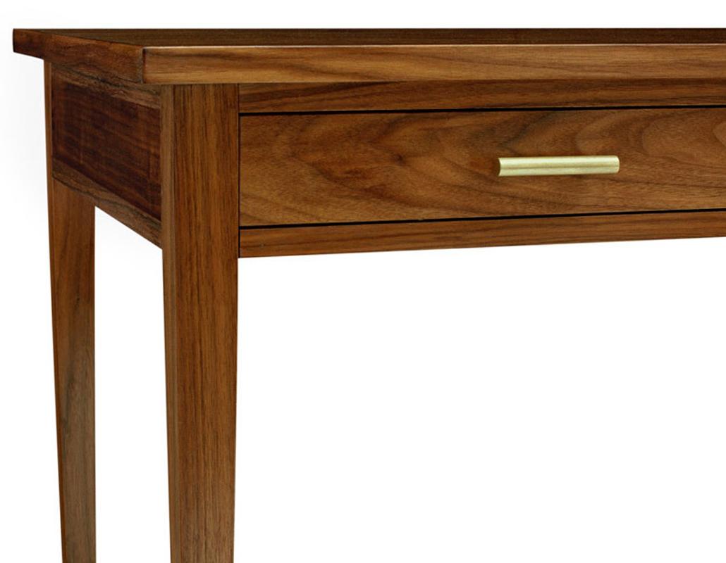 The Sebolt desk features a frame made of walnut and dovetail joinery drawers. Tapered legs are finished with patinated brass end caps. 

Made to order and handcrafted in the USA.