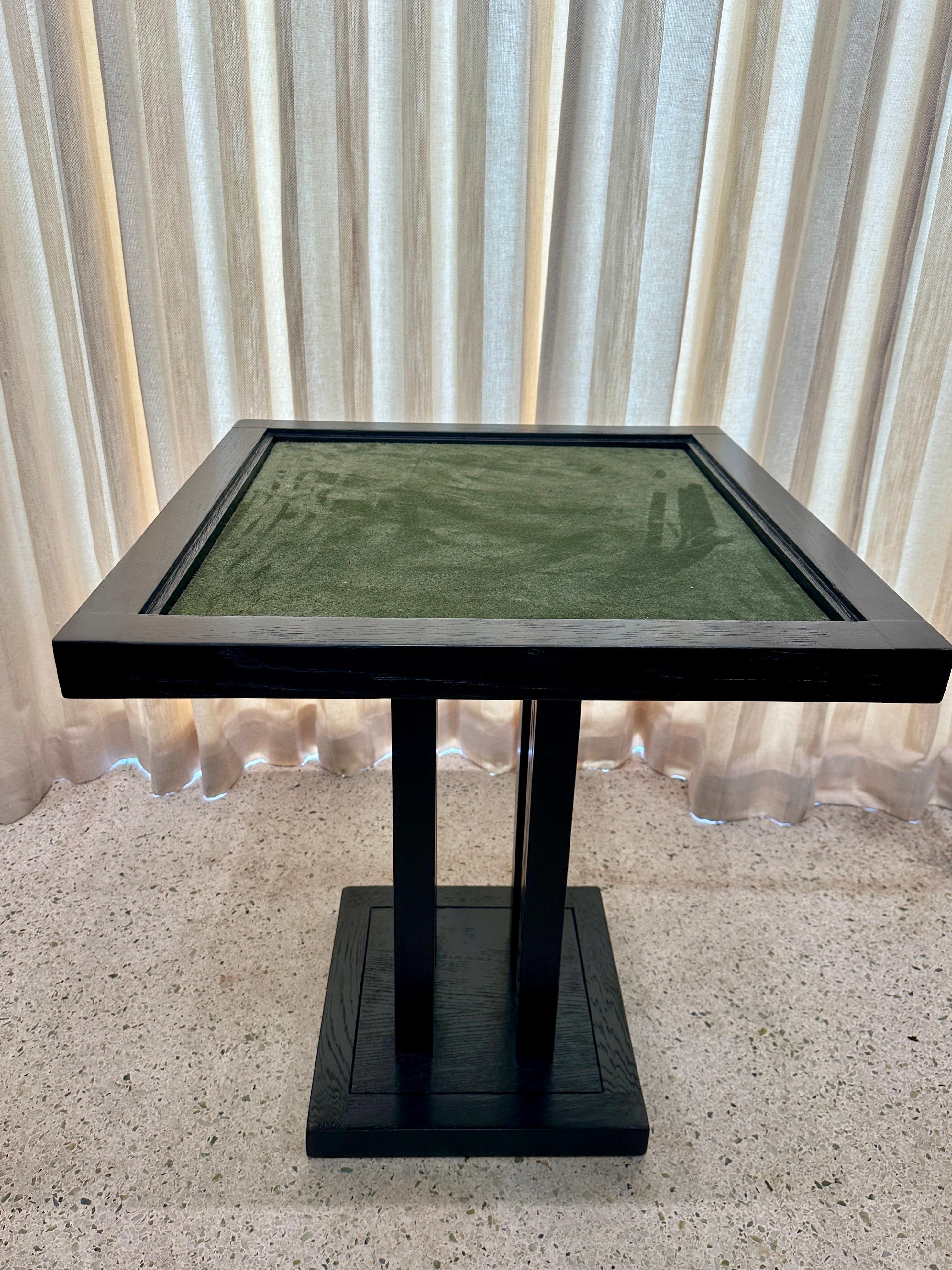 This is a wonderful small scale game table for tight spaces.  Made of high quality ebonized oak and finished with a soft deep green suede game playing top.  Dominoes, cards, just have fun!