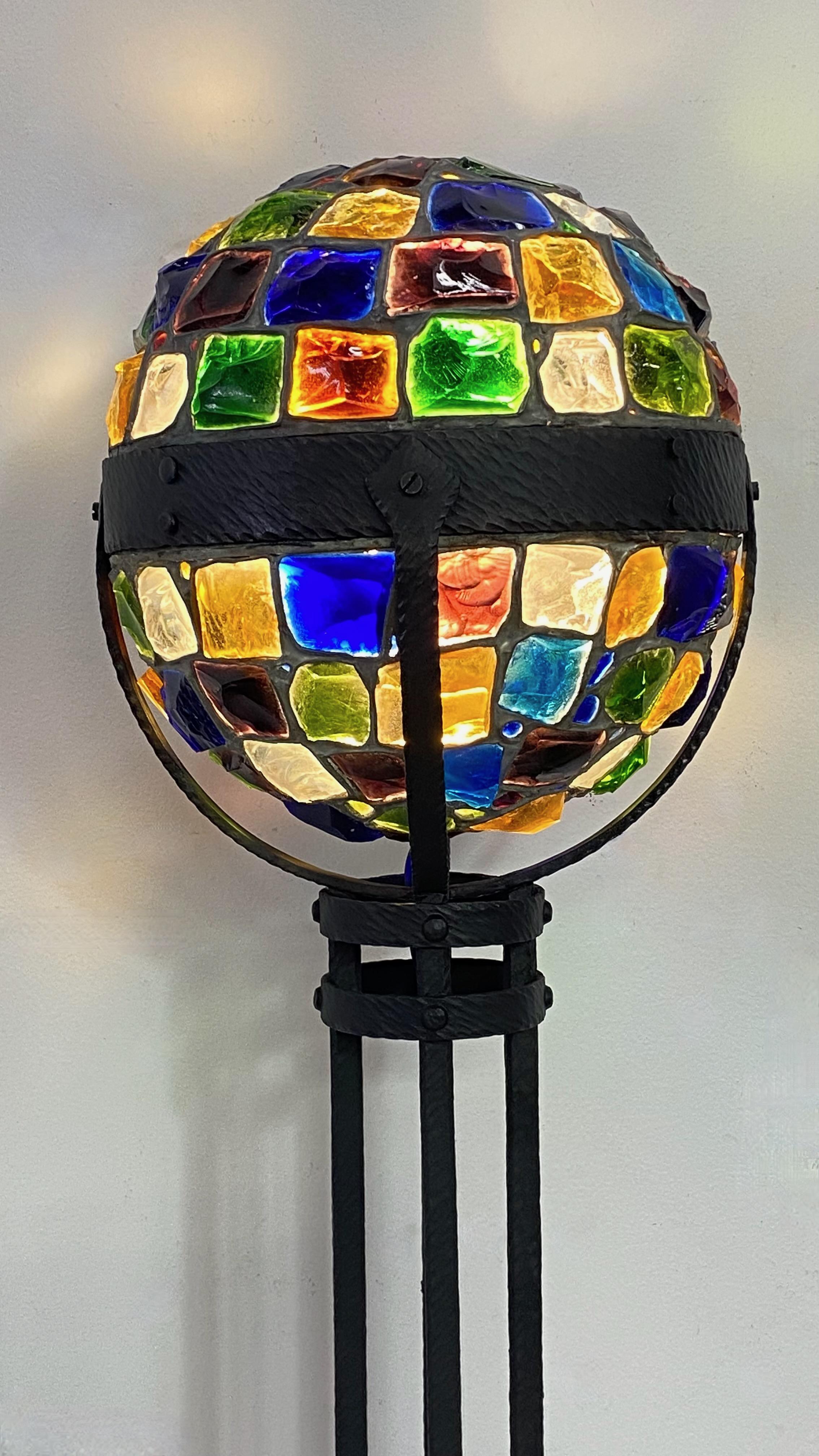 Rare and unusual Secessionist period colorful glass chunk jewel newel post lamp. Wrought iron with colorful hand cut glass jewels in vibrant colors.
Arts & Crafts - Art Nouveau Style
Recently restored and re-wired. 
The square base measures 8