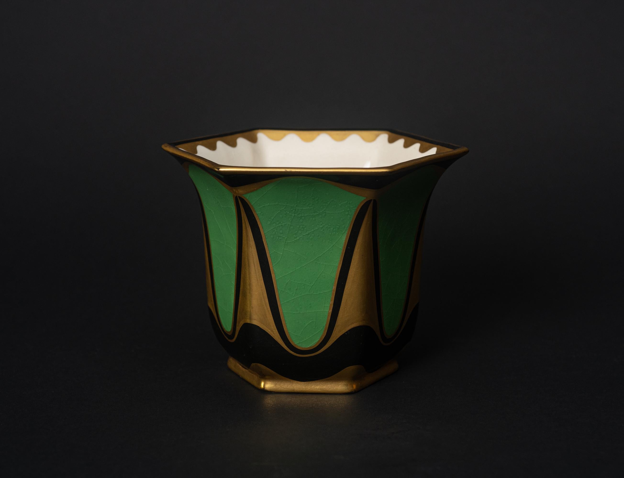 Secessionist Porcelain Lidded Box by KARL KLAUS (1889-1925) for SERAPIS WAHLISS, Vienna, c. 1911, hand-painted in gold and black enamels in a stylized geometric diamond and holly motif, the bell-shaped domed lid terminating in a cylindrical finial