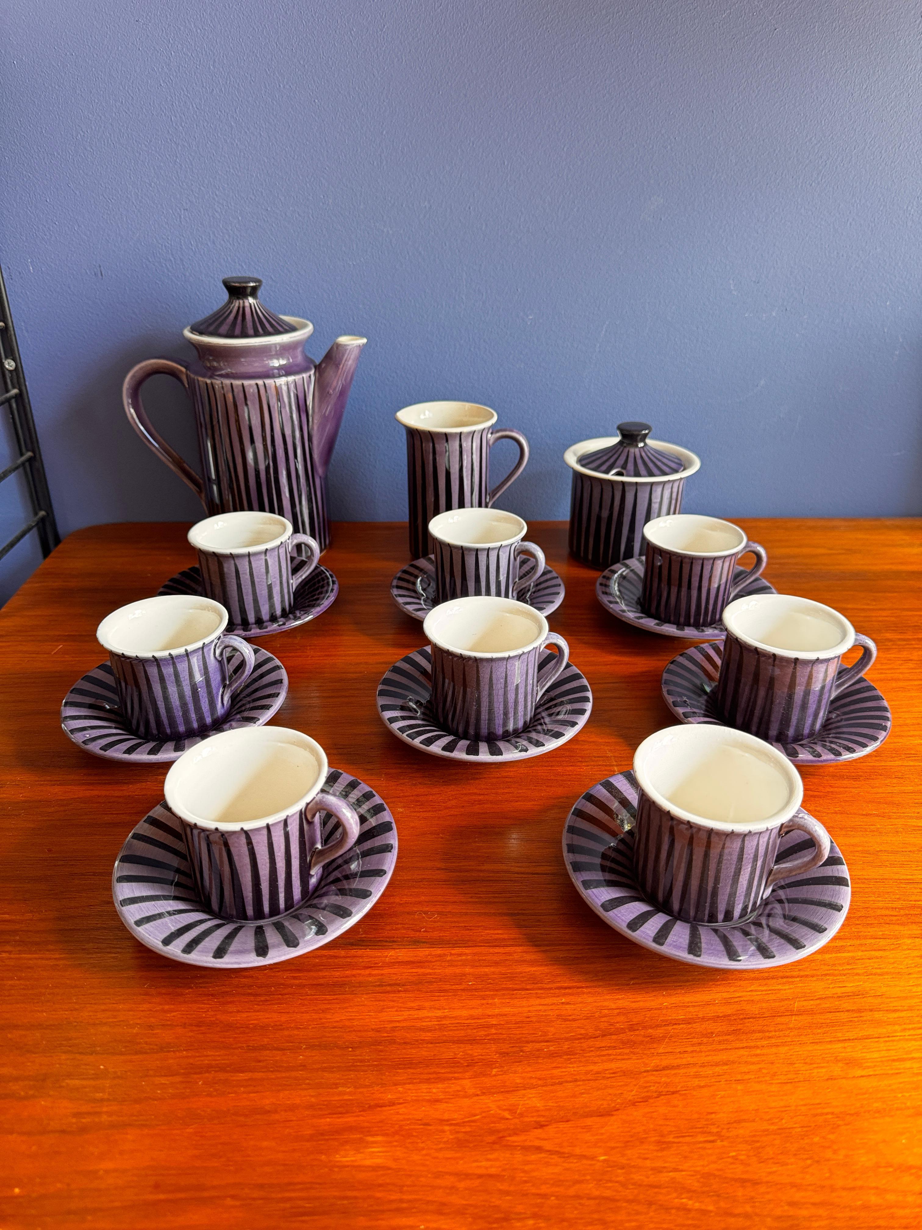An eye-catching and complete Secla coffee set from Portugal, dating to the 1970s, showcasing the brand's distinct flair for bold ceramic design. Comprising eight cups with matching saucers, a tall coffee pot, a milk jug, and a lidded sugar pot, this