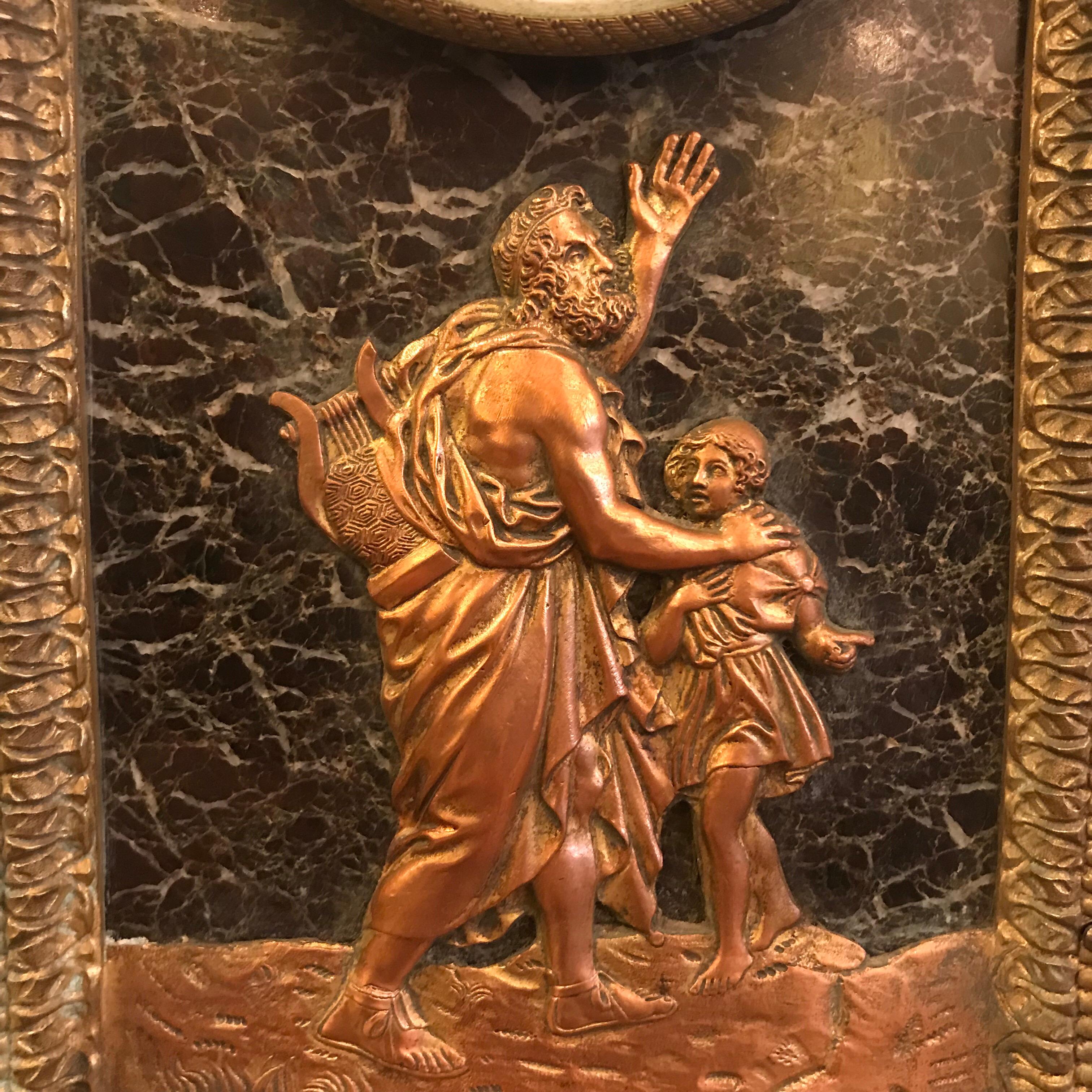 This fine French clock, in an arched verde antico marble case, is set with a bas relief panel depicting Homer. The declaiming blind poet carries his lyre, a young boy leading him. It is boldly framed in bronze and with a crisp broad acanthus band at