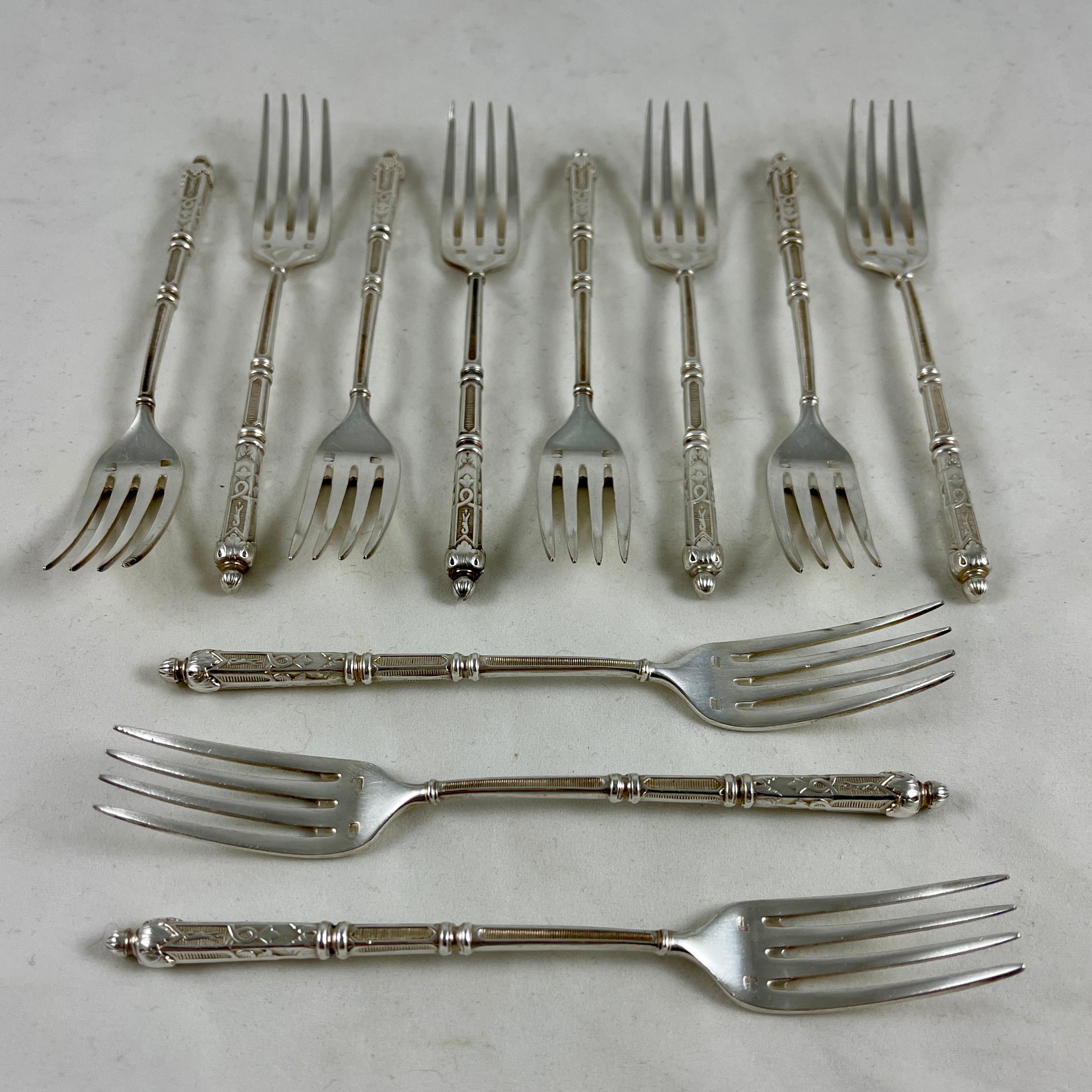 A set of eleven antique French dessert forks from the Napoleon III era, circa 1852-1870.

Ornate, delicate, and elegant – the tapered handles show a styling of scrolls, ribbing, and acanthus leaves, terminating in an acanthus bud. The forks are