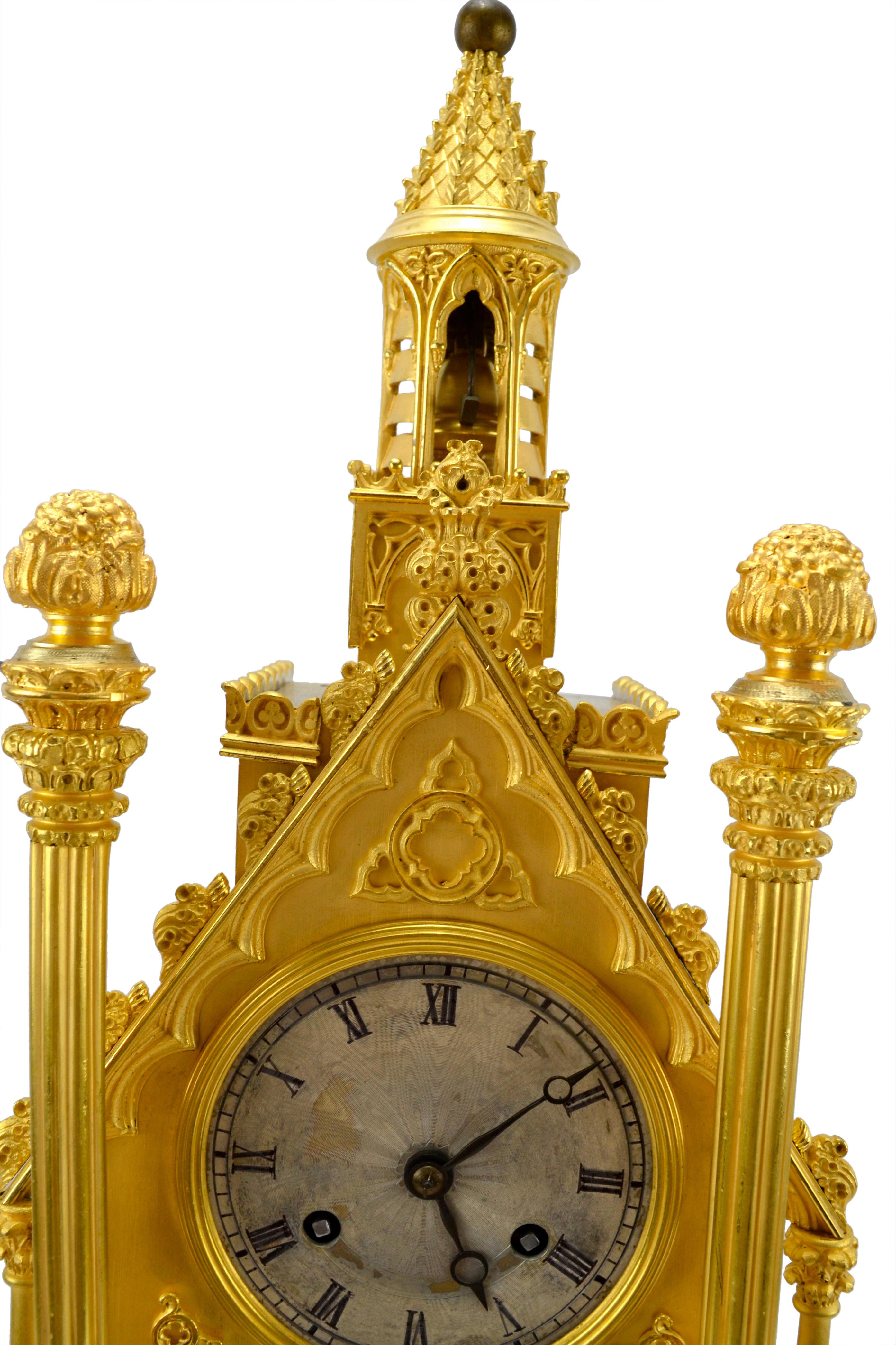 A mid 19 century French  Gilt Bronze Gothic style mantel clock and garniture which the French call 