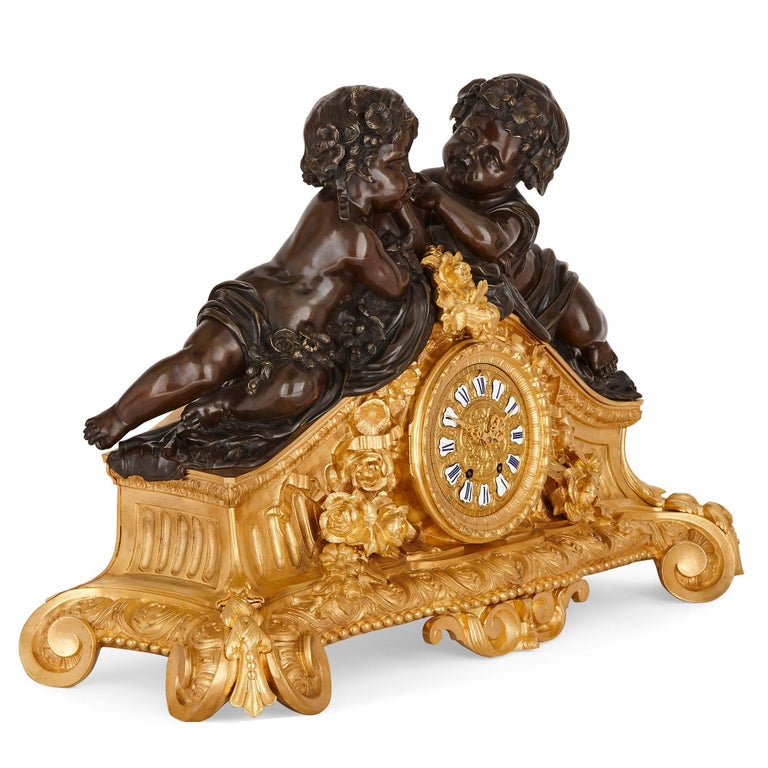 This three-piece mantel clock set contains a clock and two candelabra. The set was produced circa 1860, during the Napoleon III period, and demonstrates the eclecticism typical to decorative art of this time: the set is influenced by styles current