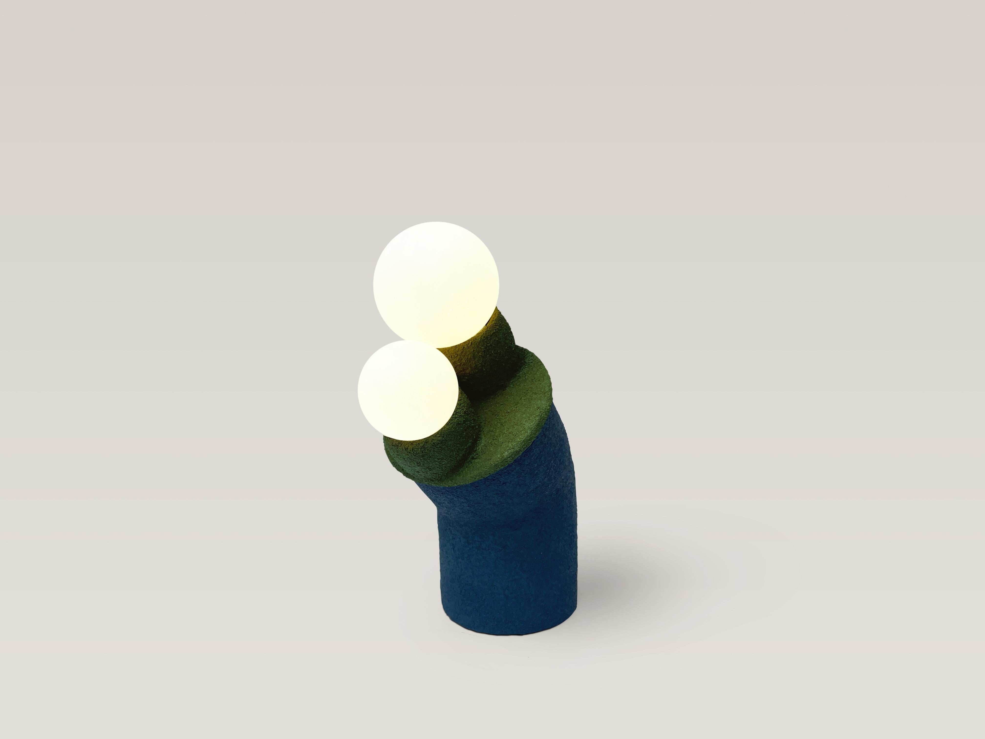 Playful table lamp. Unique piece.

Material: clay, reclaimed plastic, PVA, sand, acrylic paint, pigment, polyurethane, electrical components, glass globes, led dimmable bulbs.