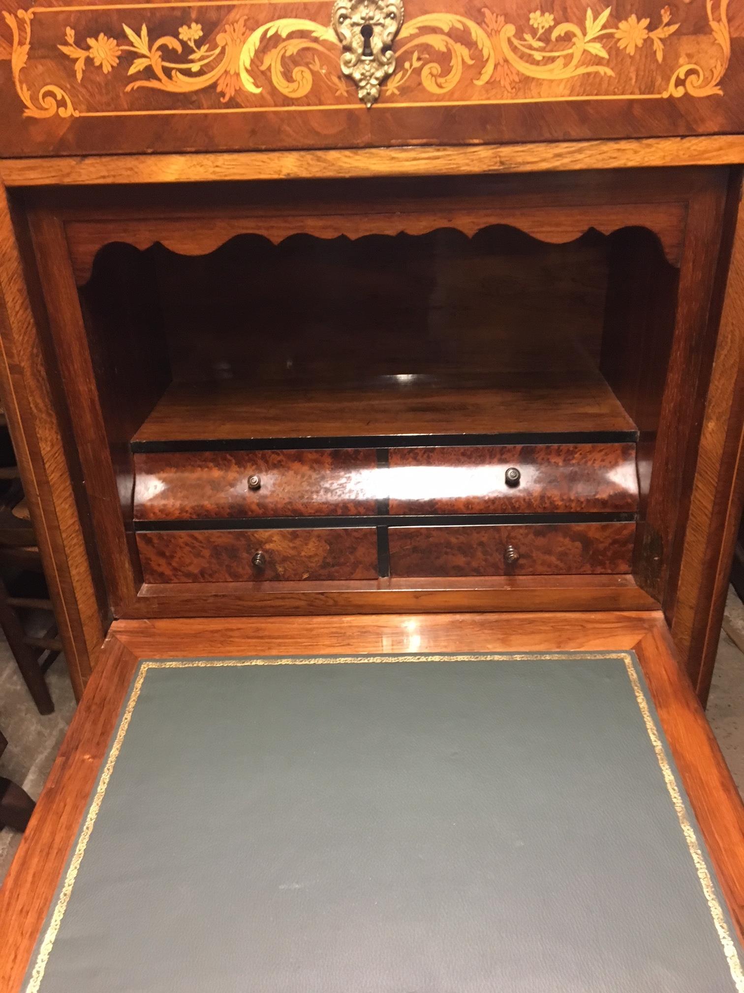 Good quality marquetry Semanier with ormolu fittings in good condition. French Circa 1910. 
This delightful antique Semanier has 4 smoothly running drawers below the central marquetry panel, This drop-down panel opens to reveal 3 stationary drawers