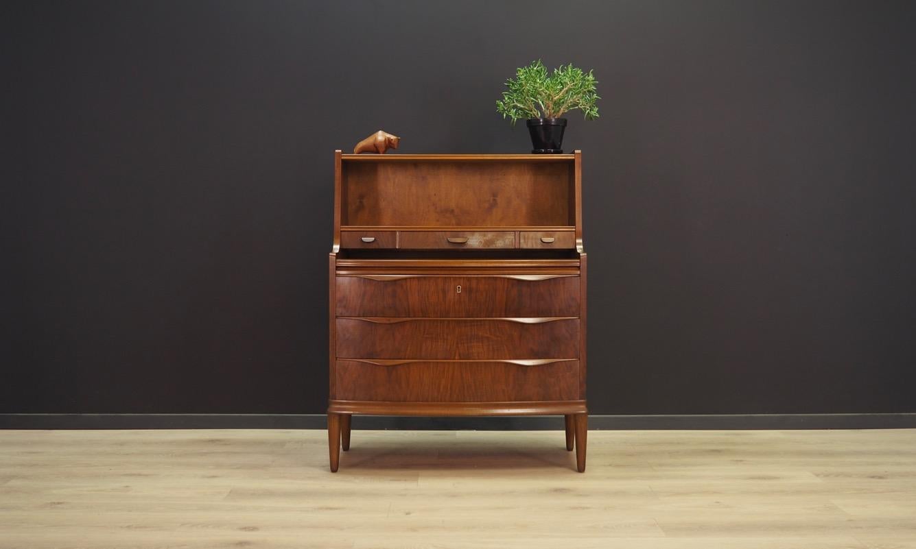 Fantastic secretaries from the 1960s-1970s. Danish design, minimalistic form. The surface of the furniture is covered with walnut veneer. The secretary has three packing drawers and three tiny drawers. The top can be pulled out. No key included.