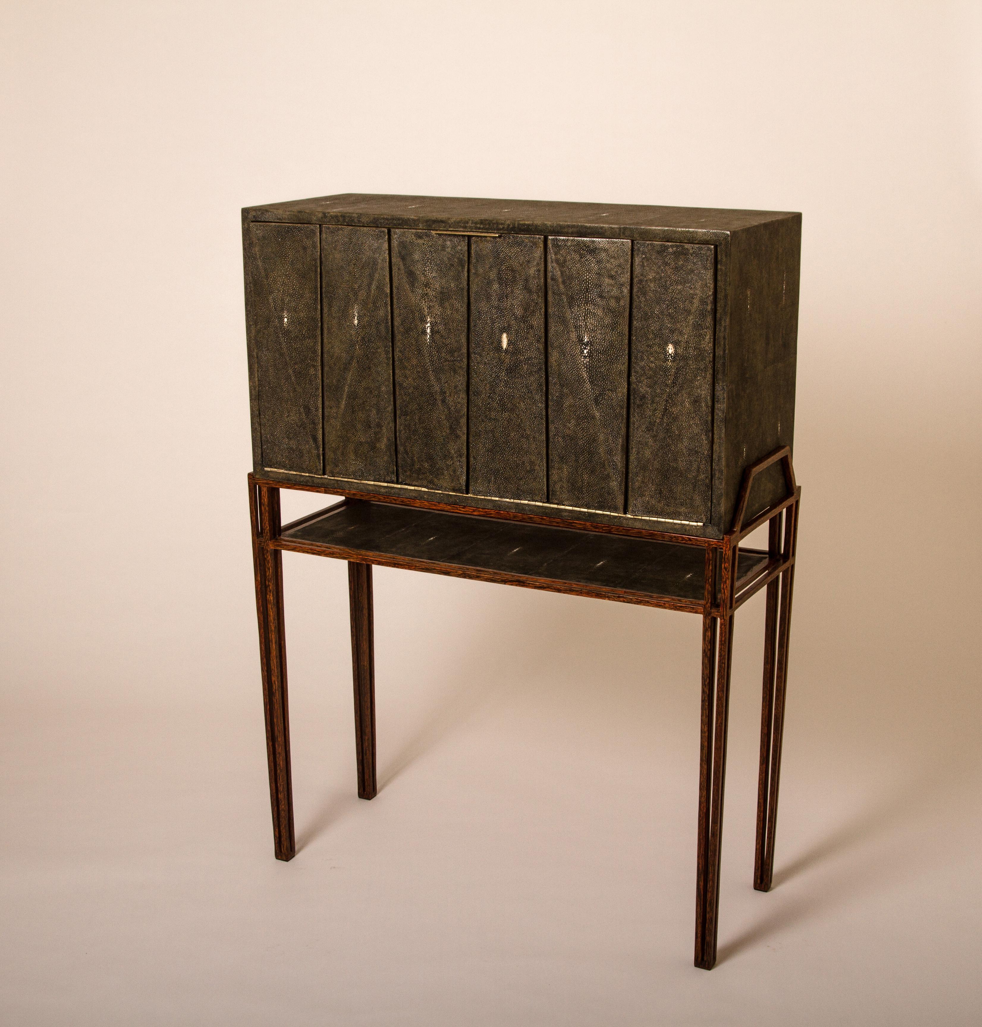 The secrétaire desk is the perfect functional working unit. The flap top opens up into a desk with several compartments, inlaid in antique black shagreen and wood veneer, to store items and once closed offers a beautiful piece to look at. The